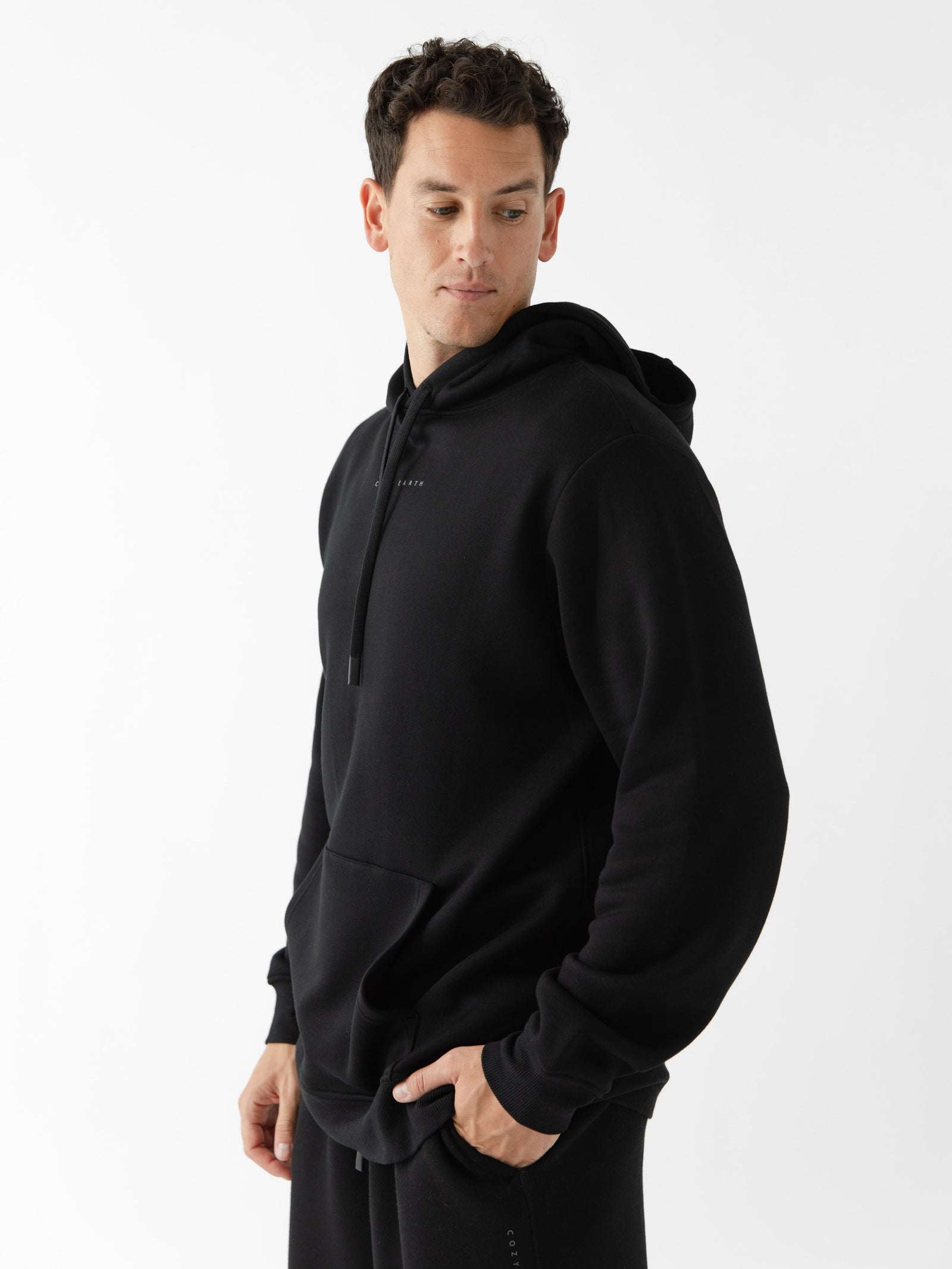 Man wearing black cityscape hoodie with white background 