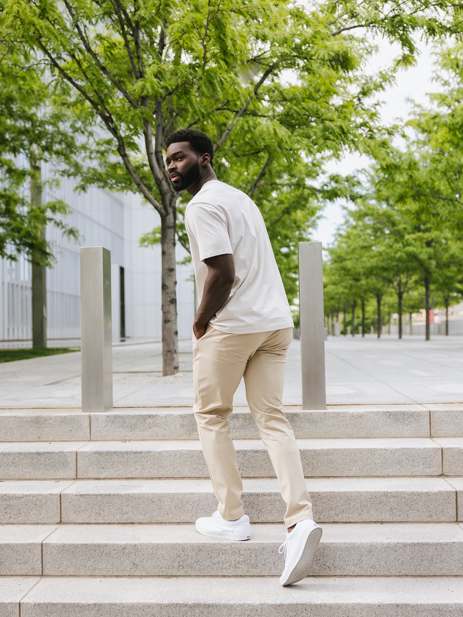 Man walking up steps in alabaster tee and khaki pants |Color:Alabaster