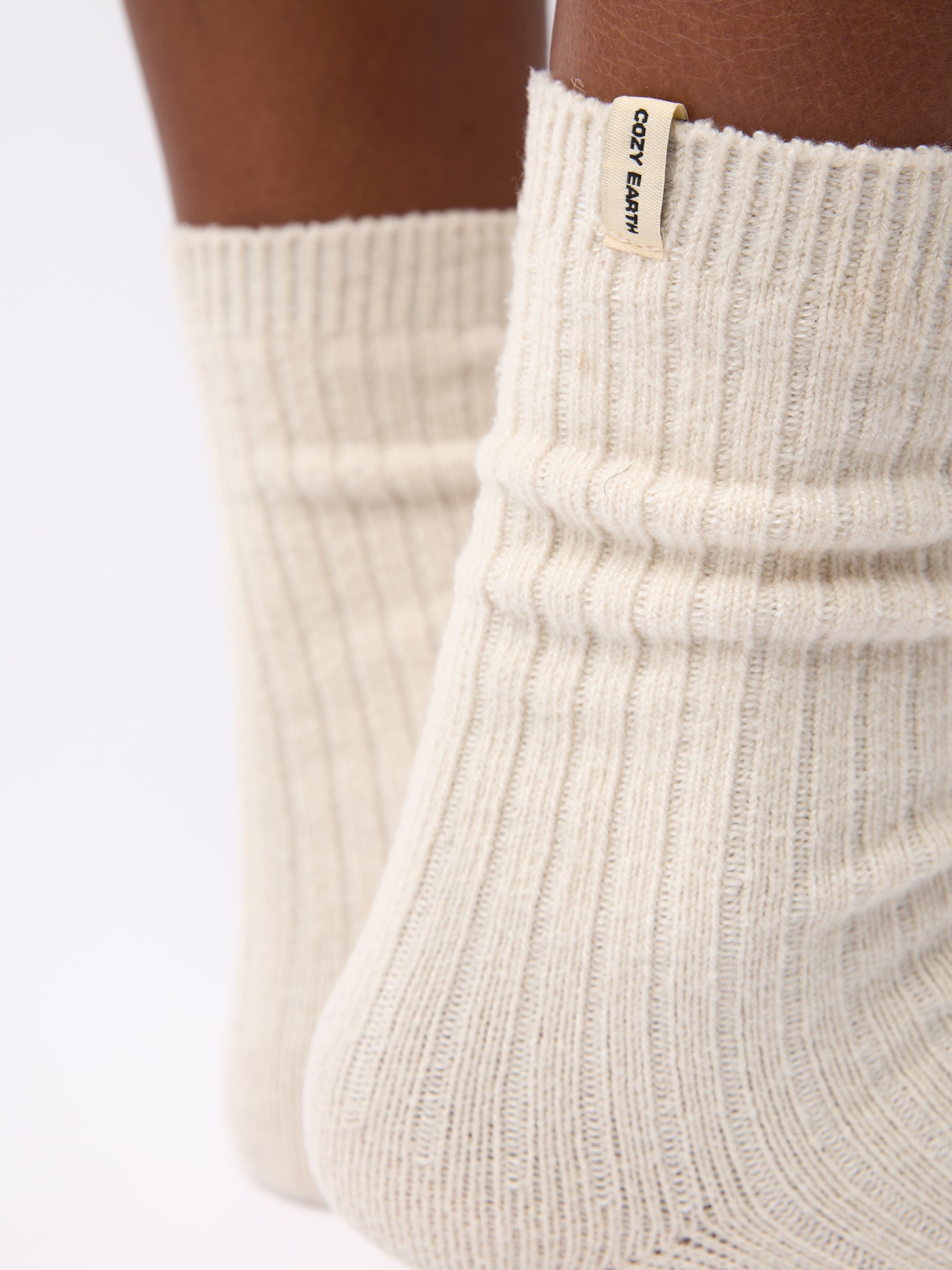 Close-up of the tag on Cozy Earth Plush Lounge Sock 1-Pack in Alabaster 