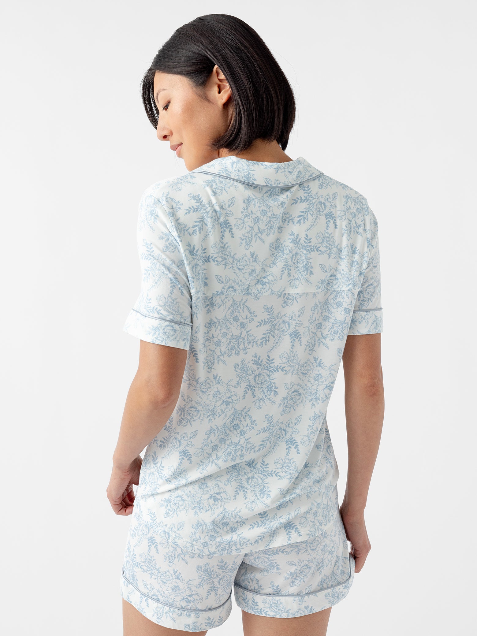 Back of woman in blue toile short sleeve pajama top 