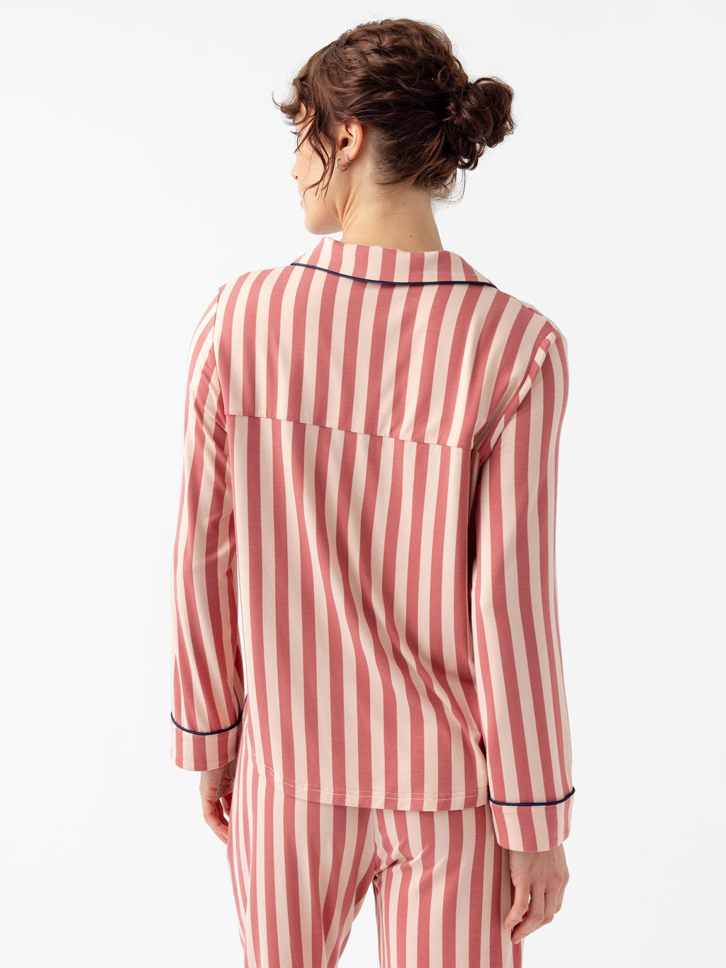 Back of woman wearing blush stripe pajama set 