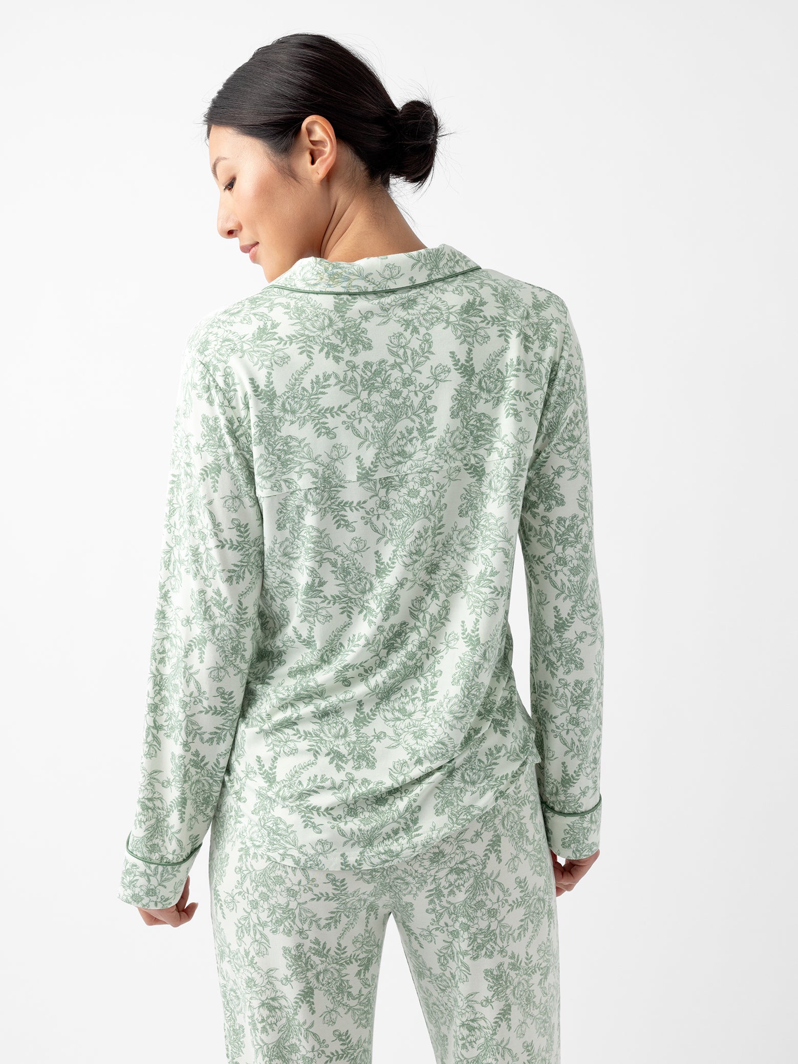 Back of woman in celadon toile pajama top 