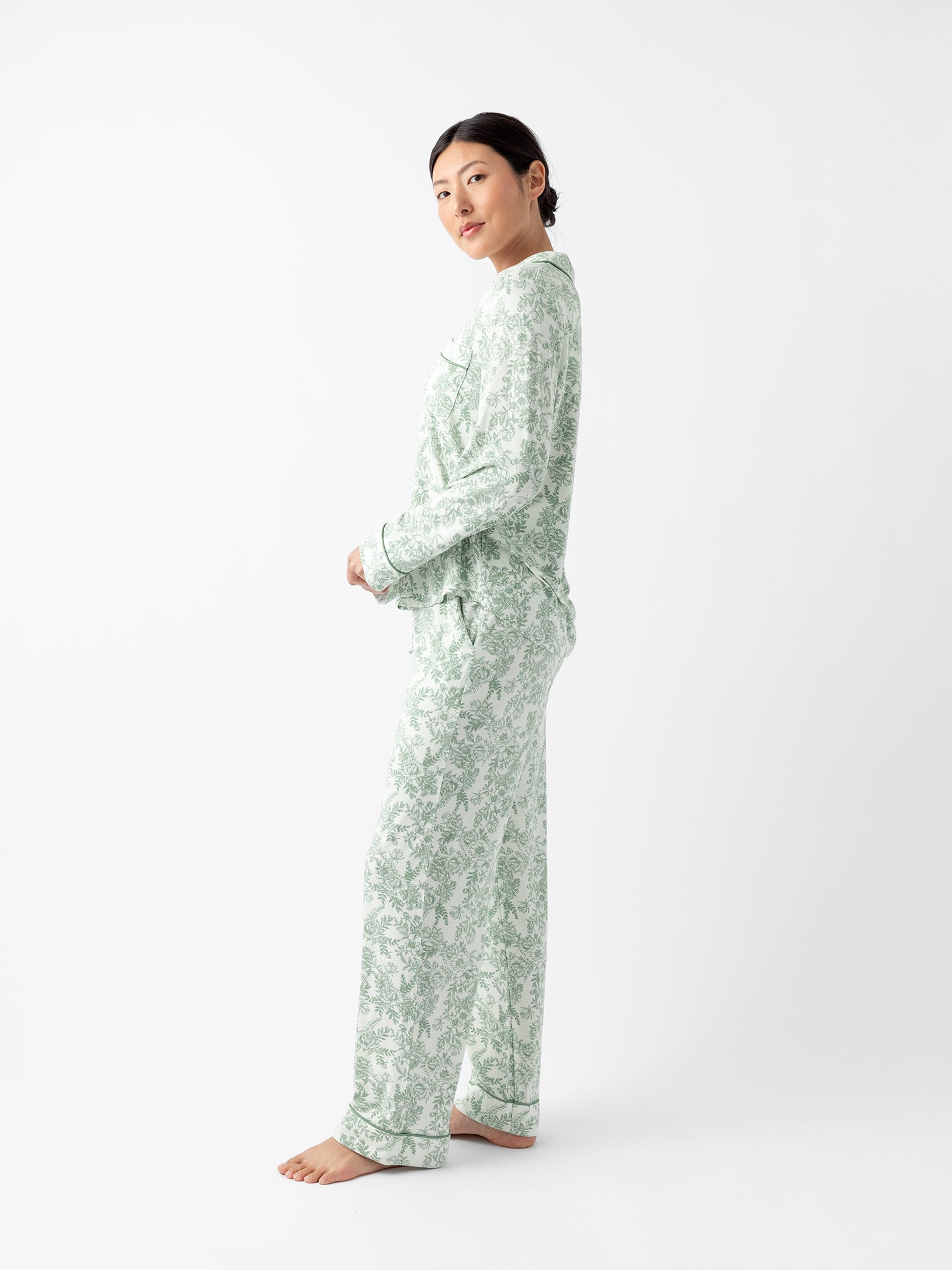 Side view of woman in celadon toile pajama set 