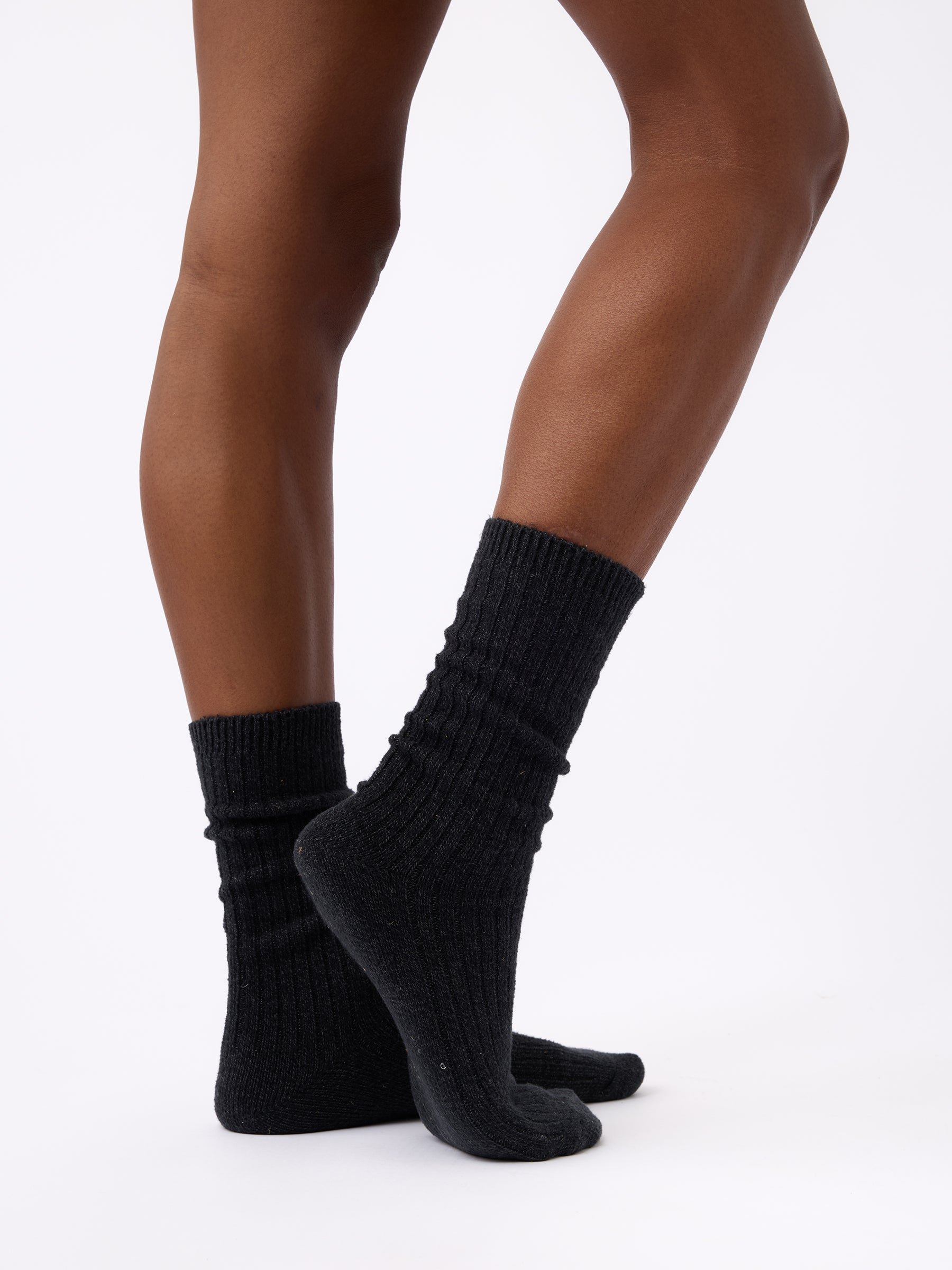 Person wearing Cozy Earth Plush Lounge Sock 3-Pack in Charcoal 