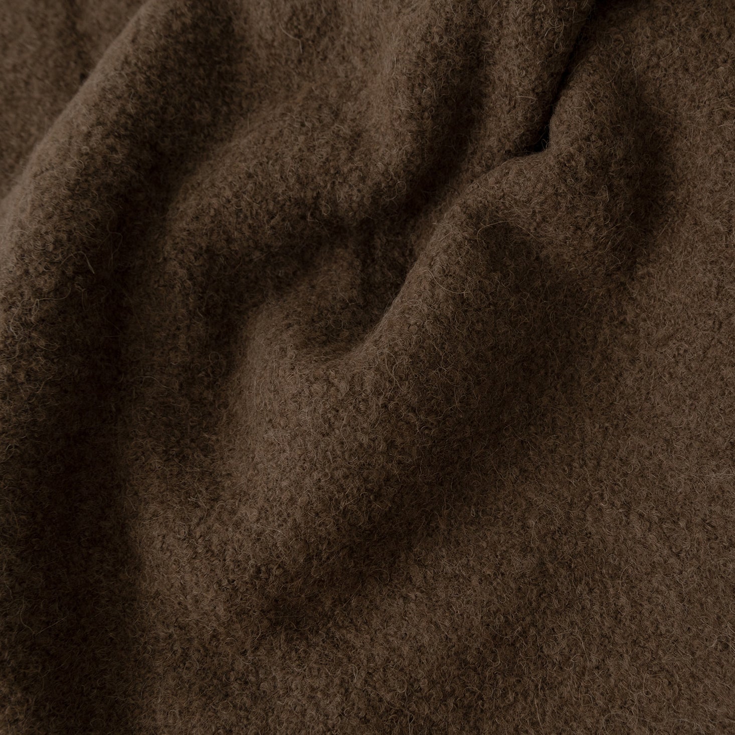 Close up of coffee boucle throw fabric 