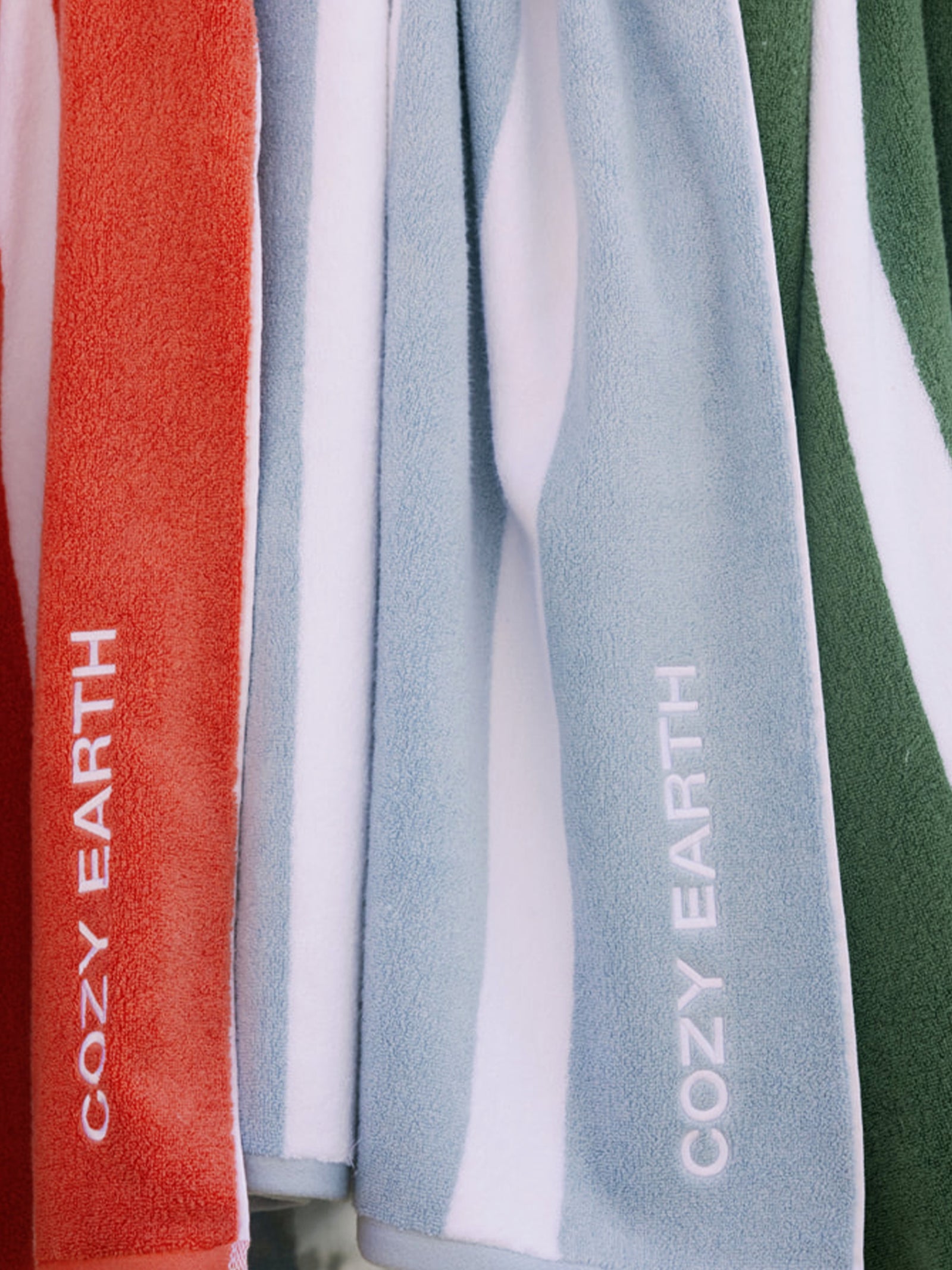 Coral, Breeze, and Sage Stripe resort towels close up