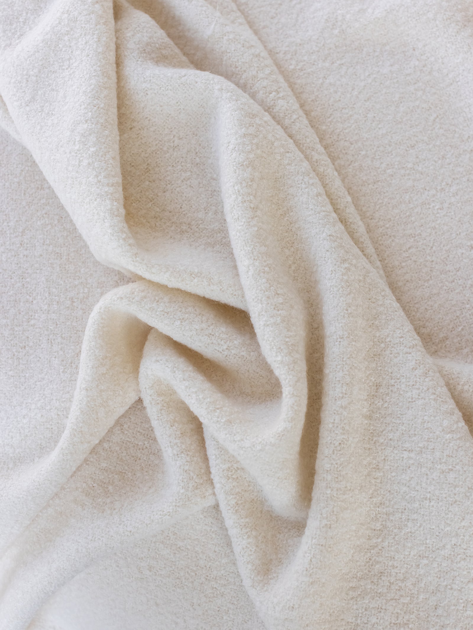 Close up of creme boucle throw fabric 