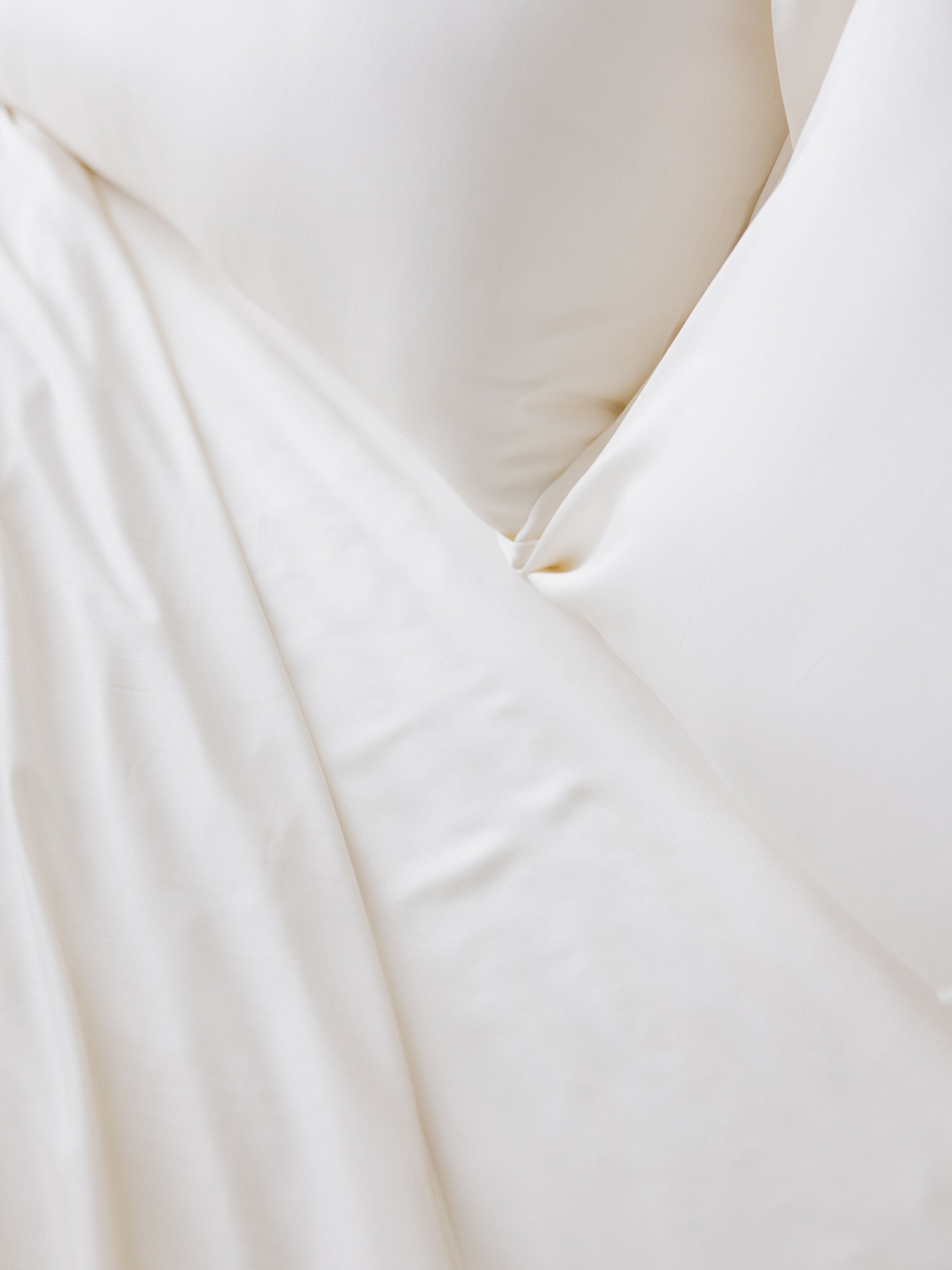 Close up of creme bedding on bed |Color:Creme