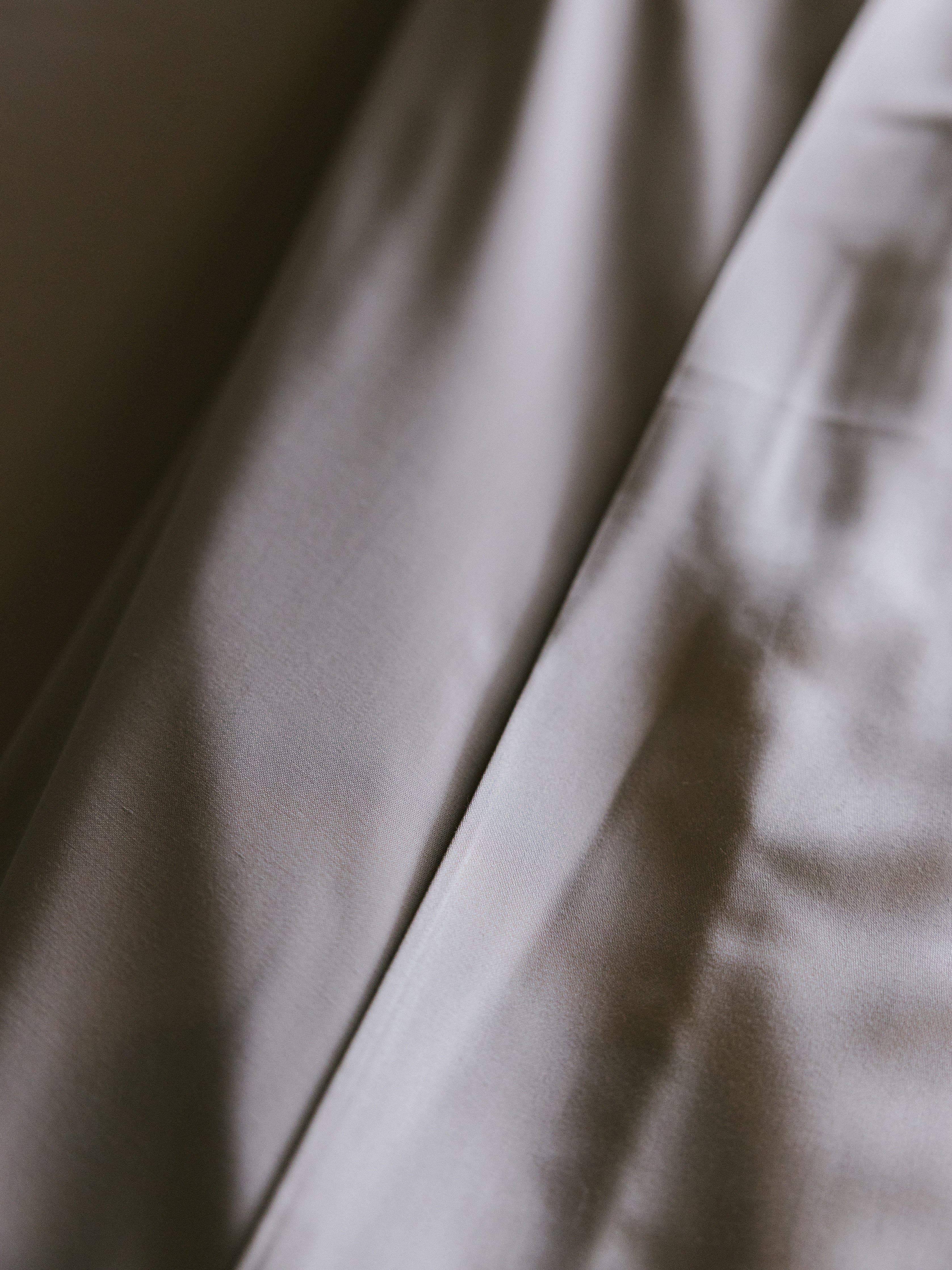 Close up of dove grey bedding 