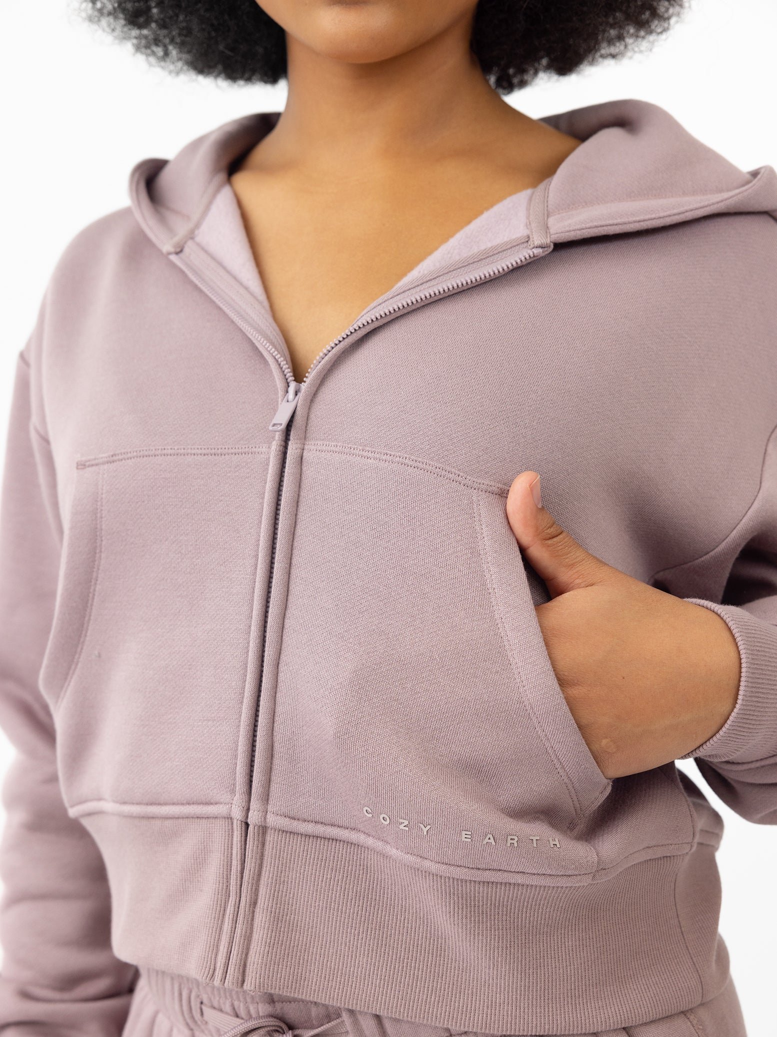 Woman wearing Dusty Orchid CityScape Cropped Full Zip with white background 