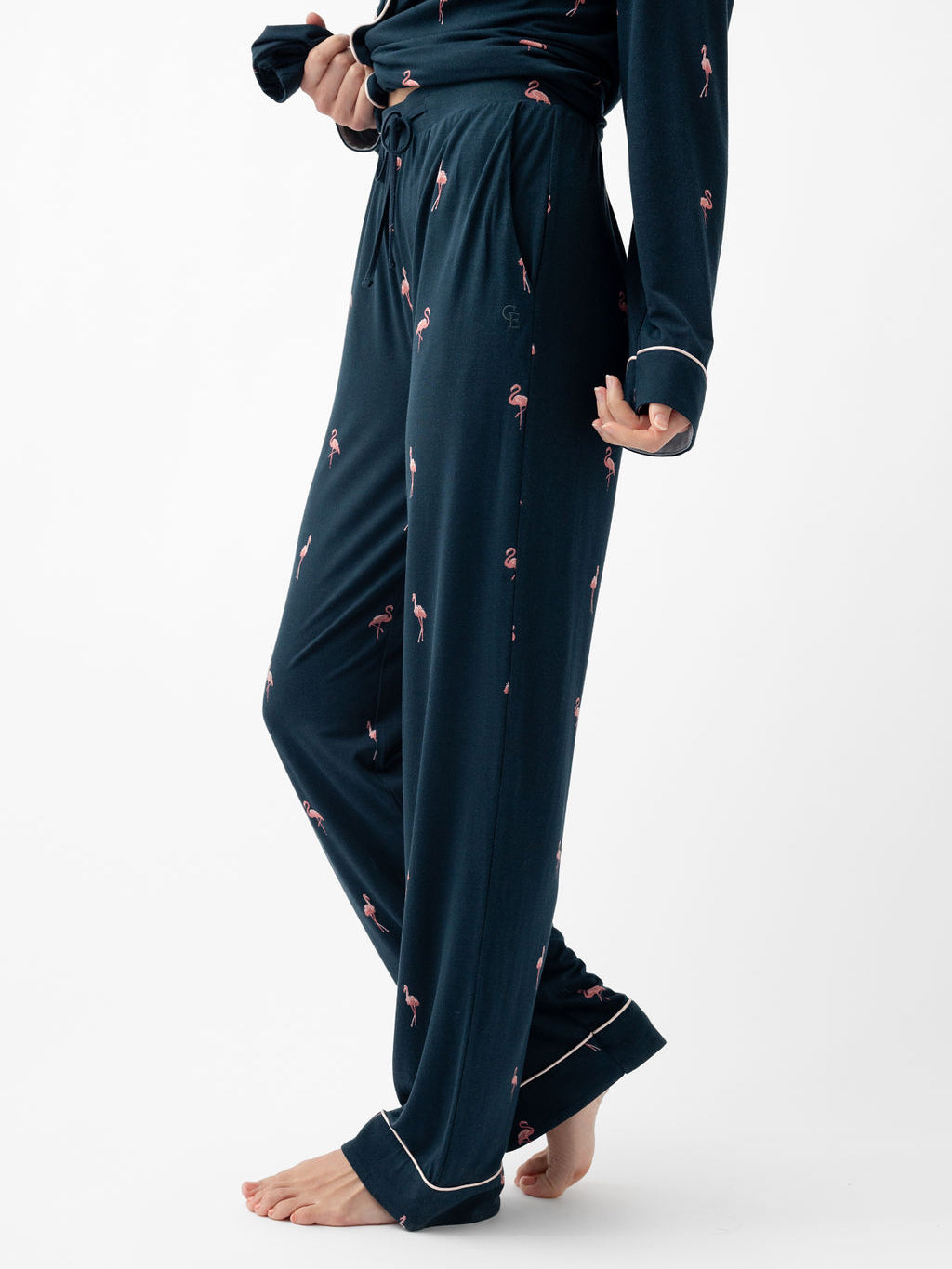 Waist down of woman wearing flamingo print long sleeve pajamas 