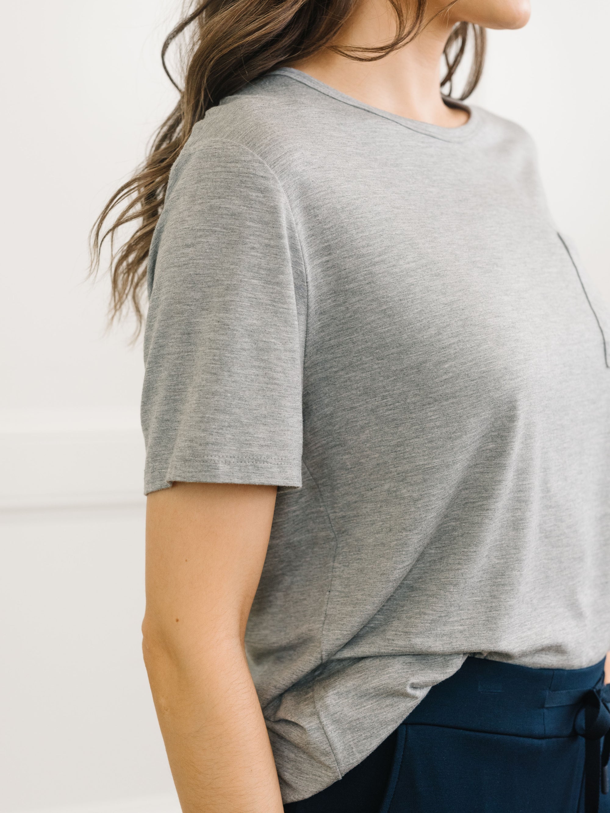 Close up detail of a woman wearing Cozy Earth Bamboo Lounge Tee in grey 
