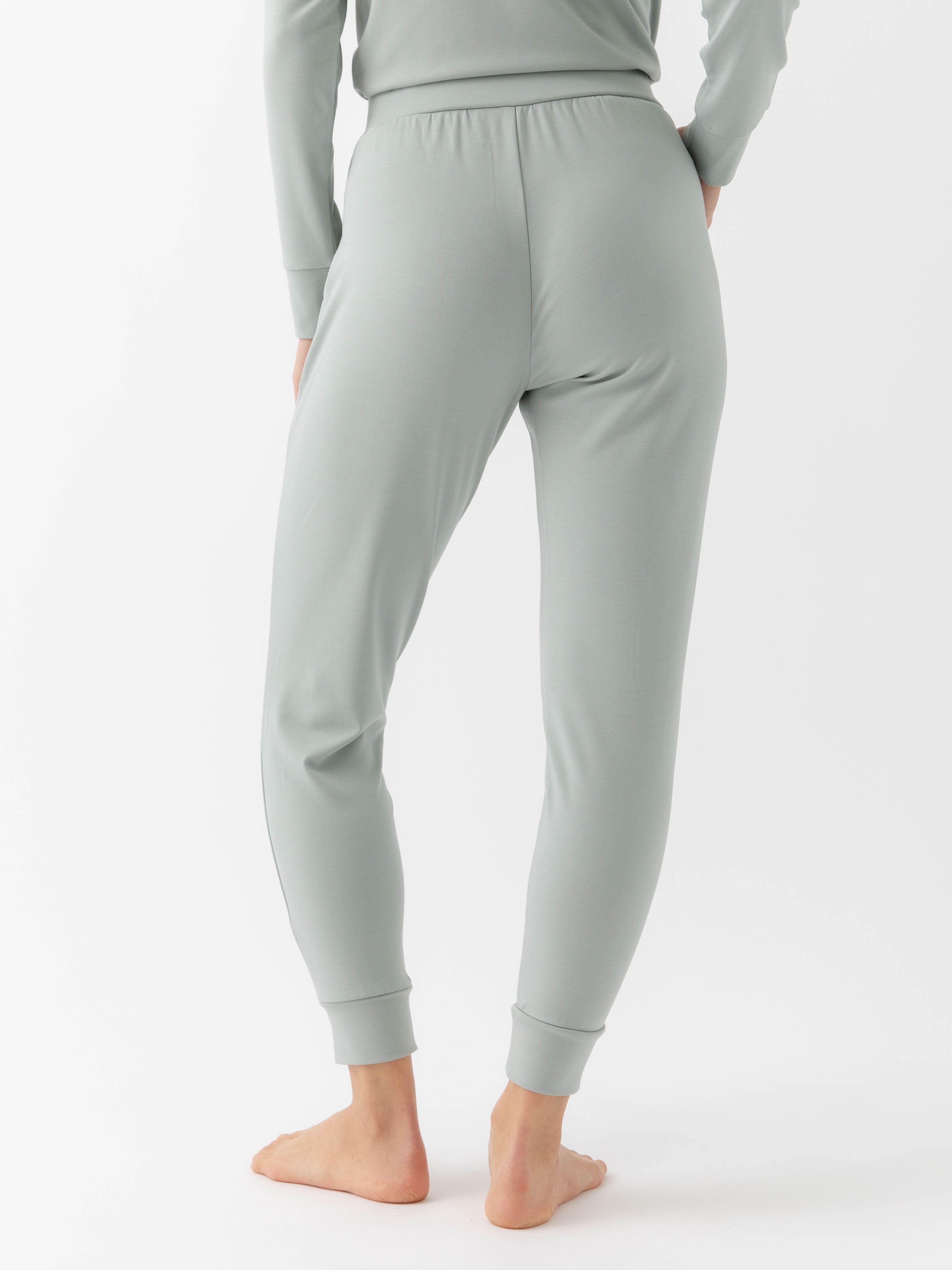 Haze Bamboo Jogger Set modeled by a woman. The photo was taken in a high contrast setting, showing off the colors and lines of the pajamas. 