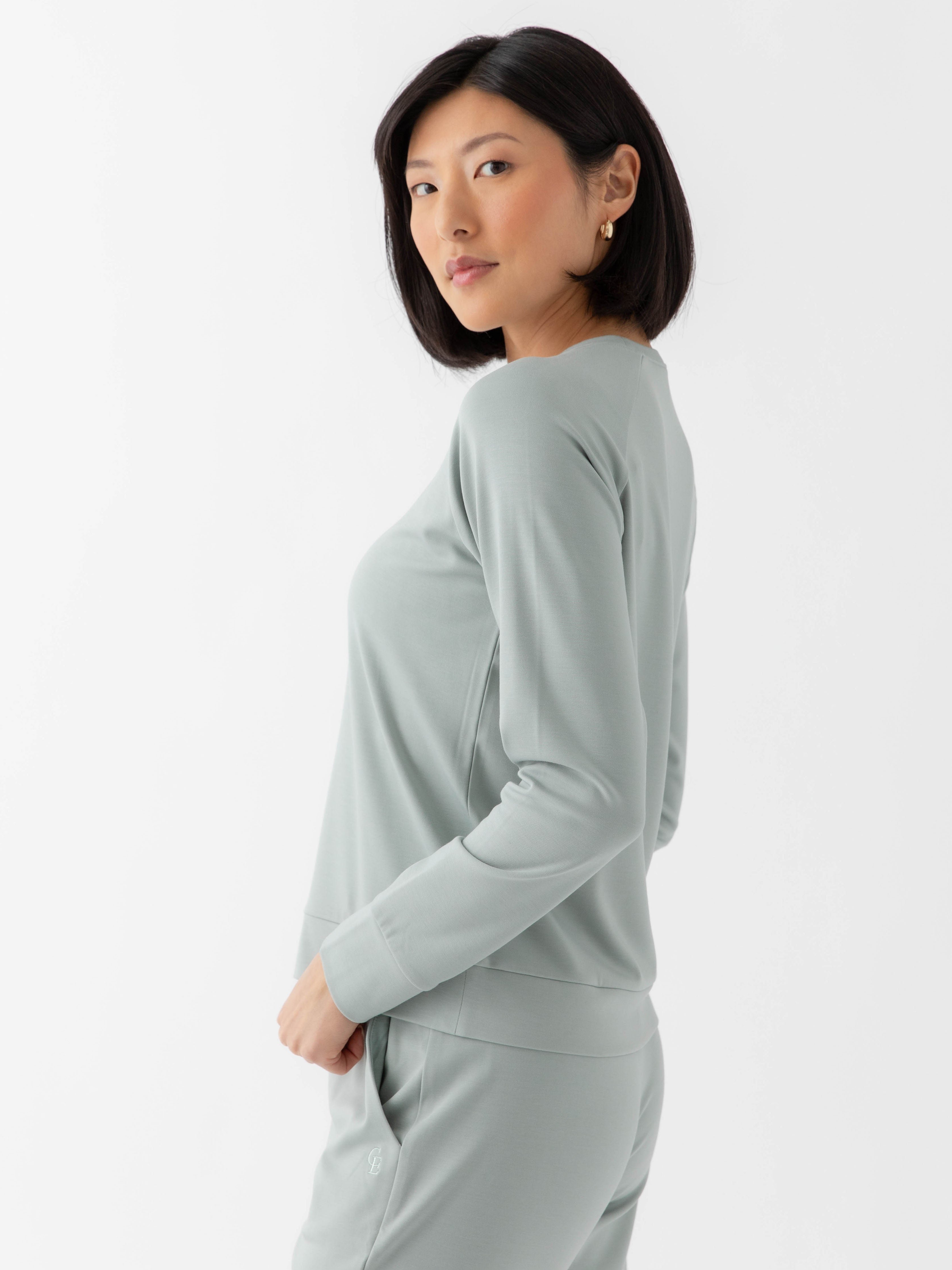 Haze Bamboo Jogger Set modeled by a woman. The photo was taken in a high contrast setting, showing off the colors and lines of the pajamas. 