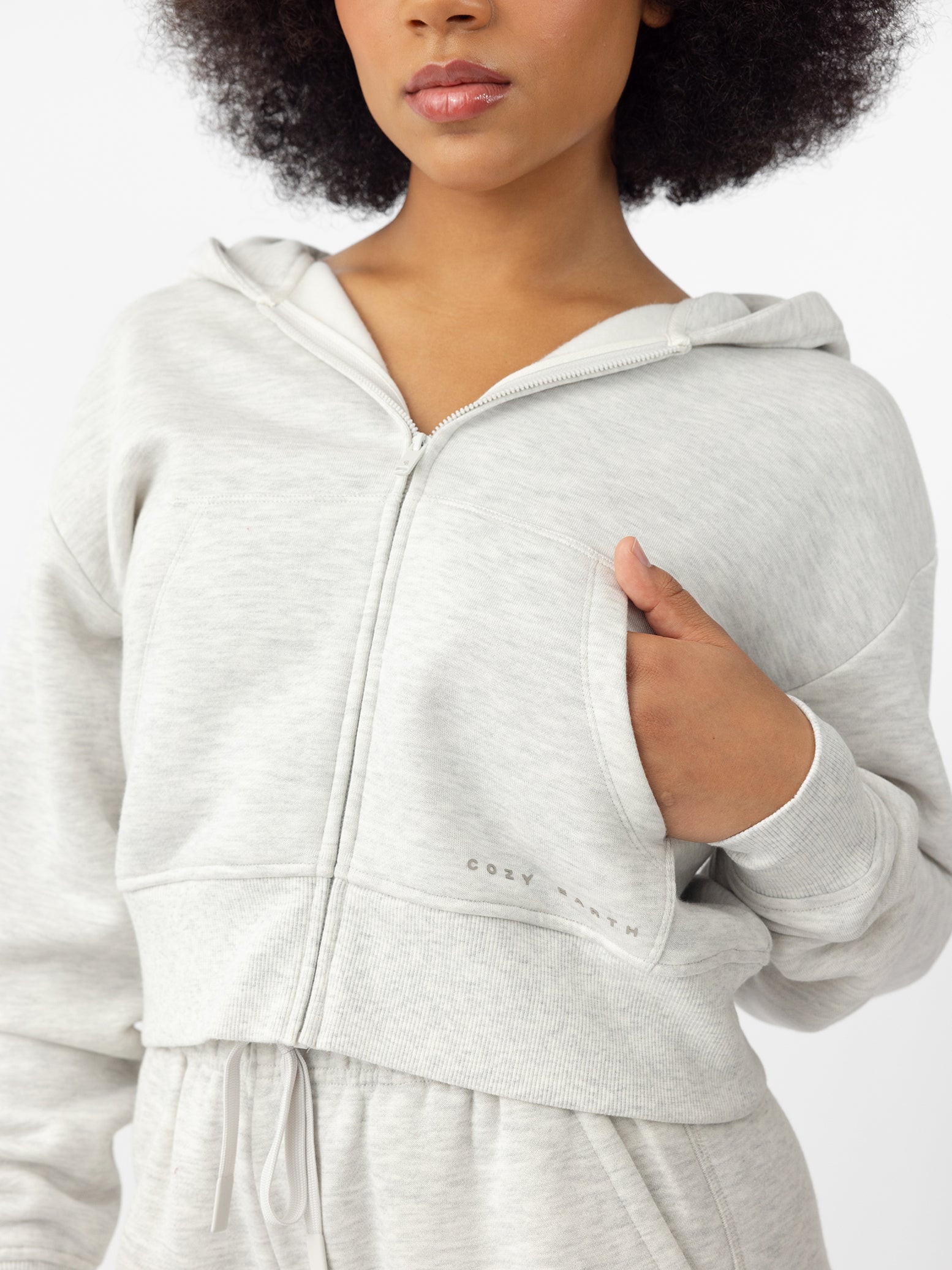 Woman wearing Heather Grey CityScape Cropped Full Zip with white background |Color: Heather Grey