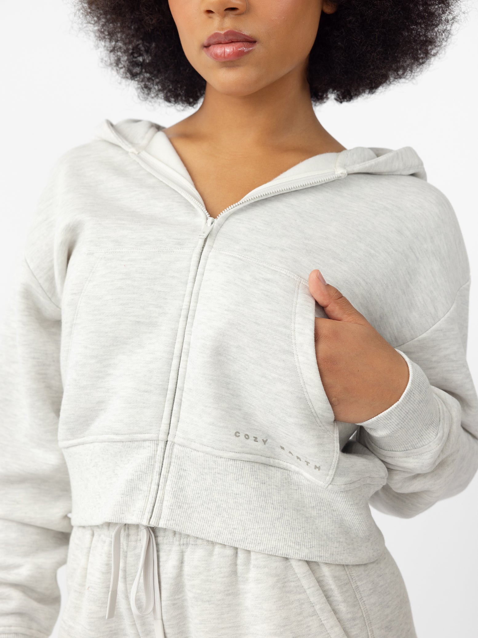 Woman wearing Heather Grey CityScape Cropped Full Zip with white background 