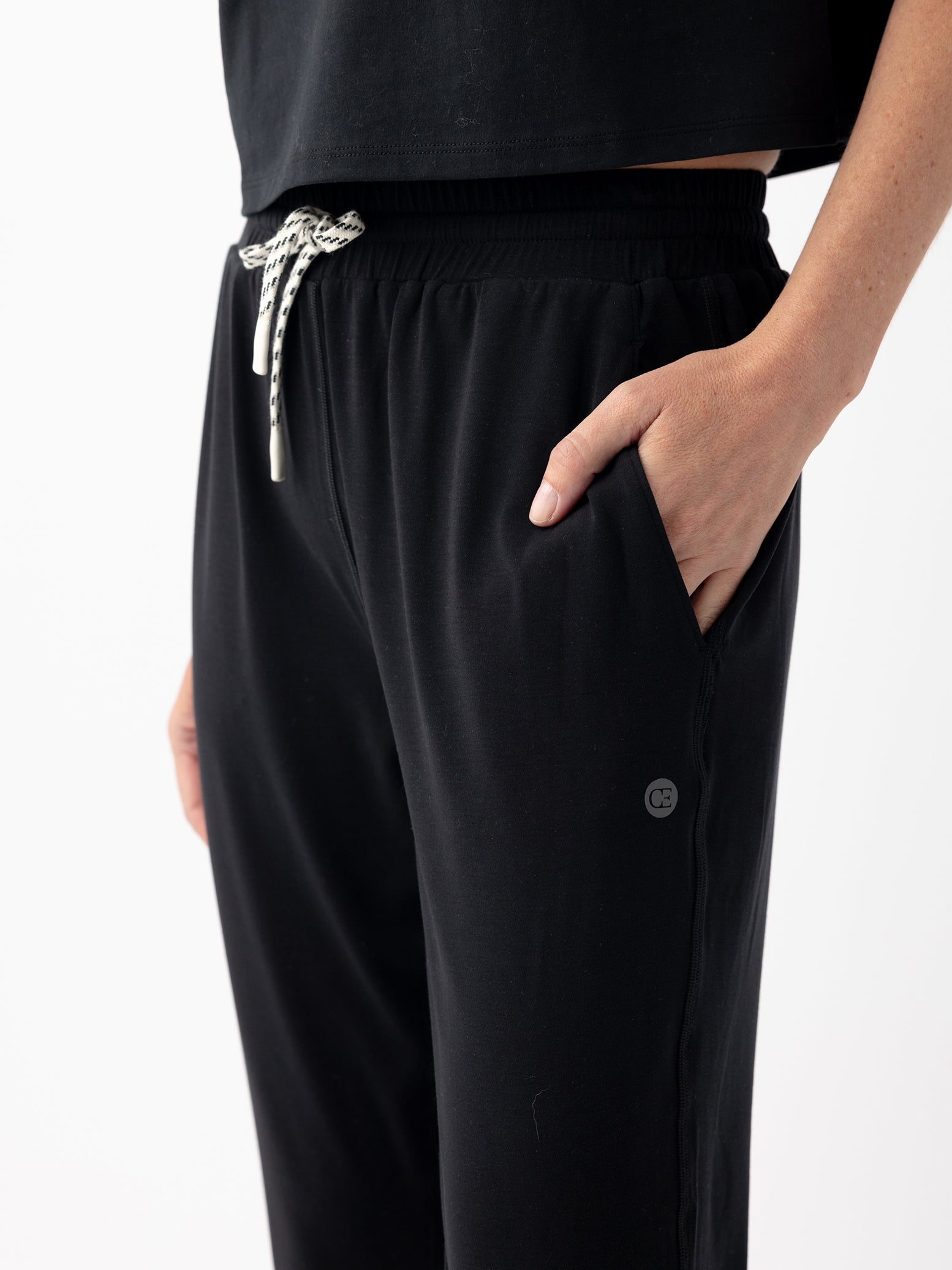 Jet Black Studio Jogger. The Studio Joggers are worn by a woman photographed with a white background. 