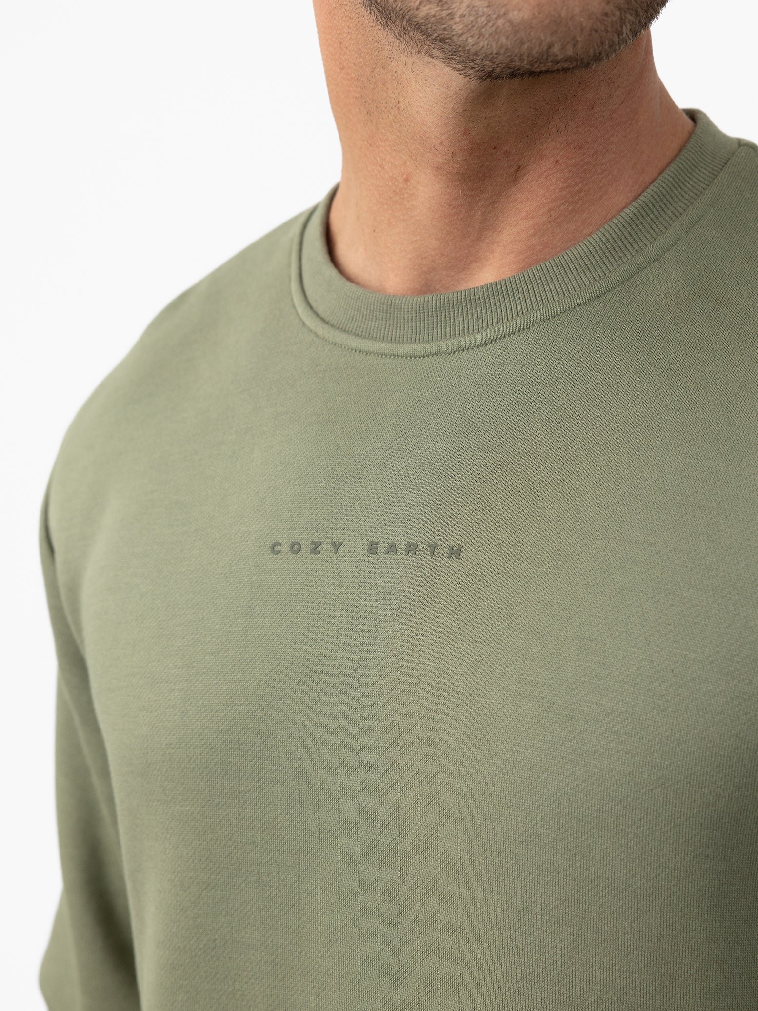 Man wearing Juniper cityscape crewneck with white background 