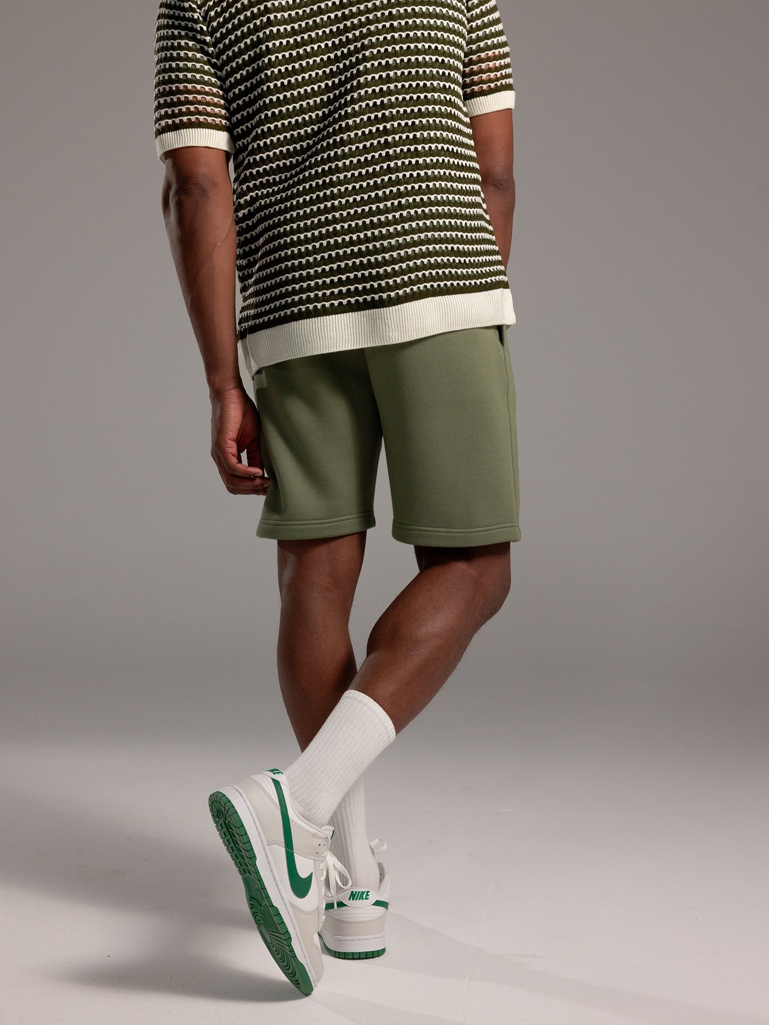 Man wearing Juniper CityScape Shorts with grey background 