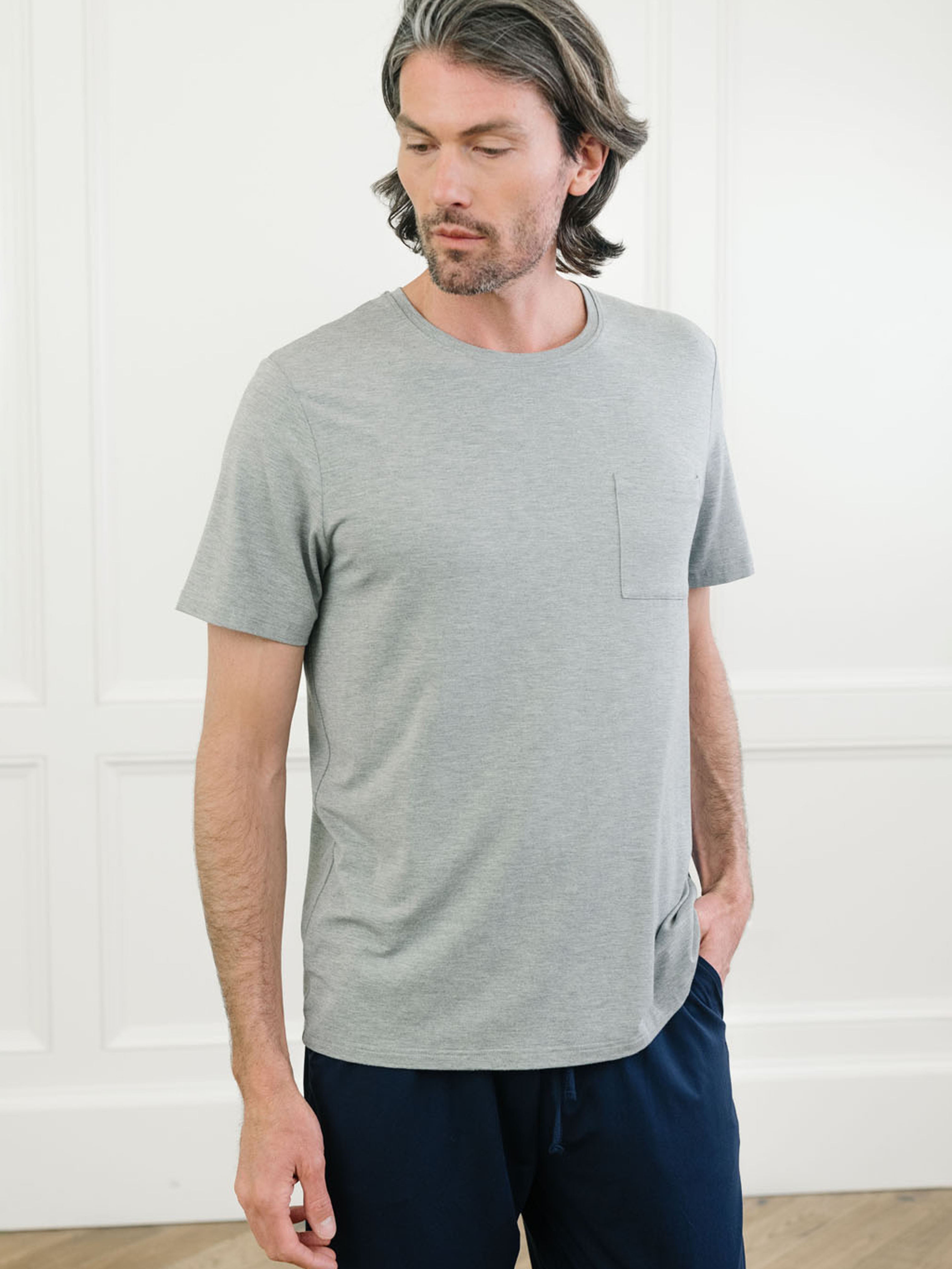 Heather grey Men's Stretch-Knit Bamboo Lounge Tee. A man is wearing the lounge tee in a well lit home.|Color:Heather Grey