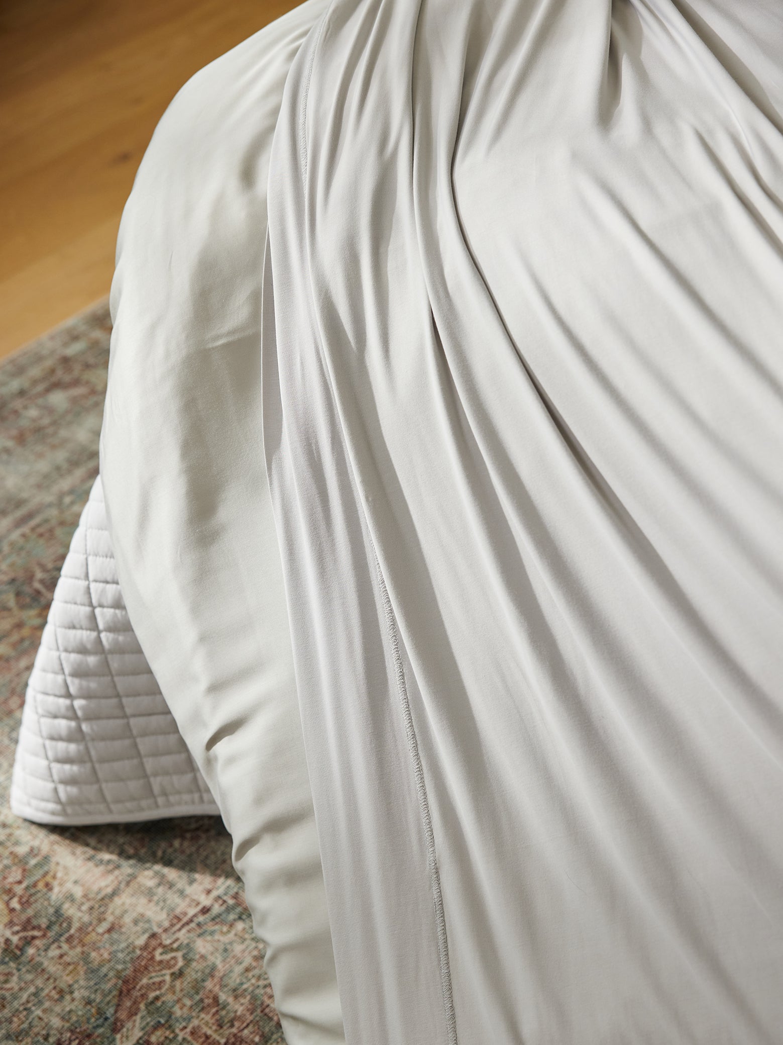 Corner of bed made with light grey bamboo jersey sheets |Color:Light Grey