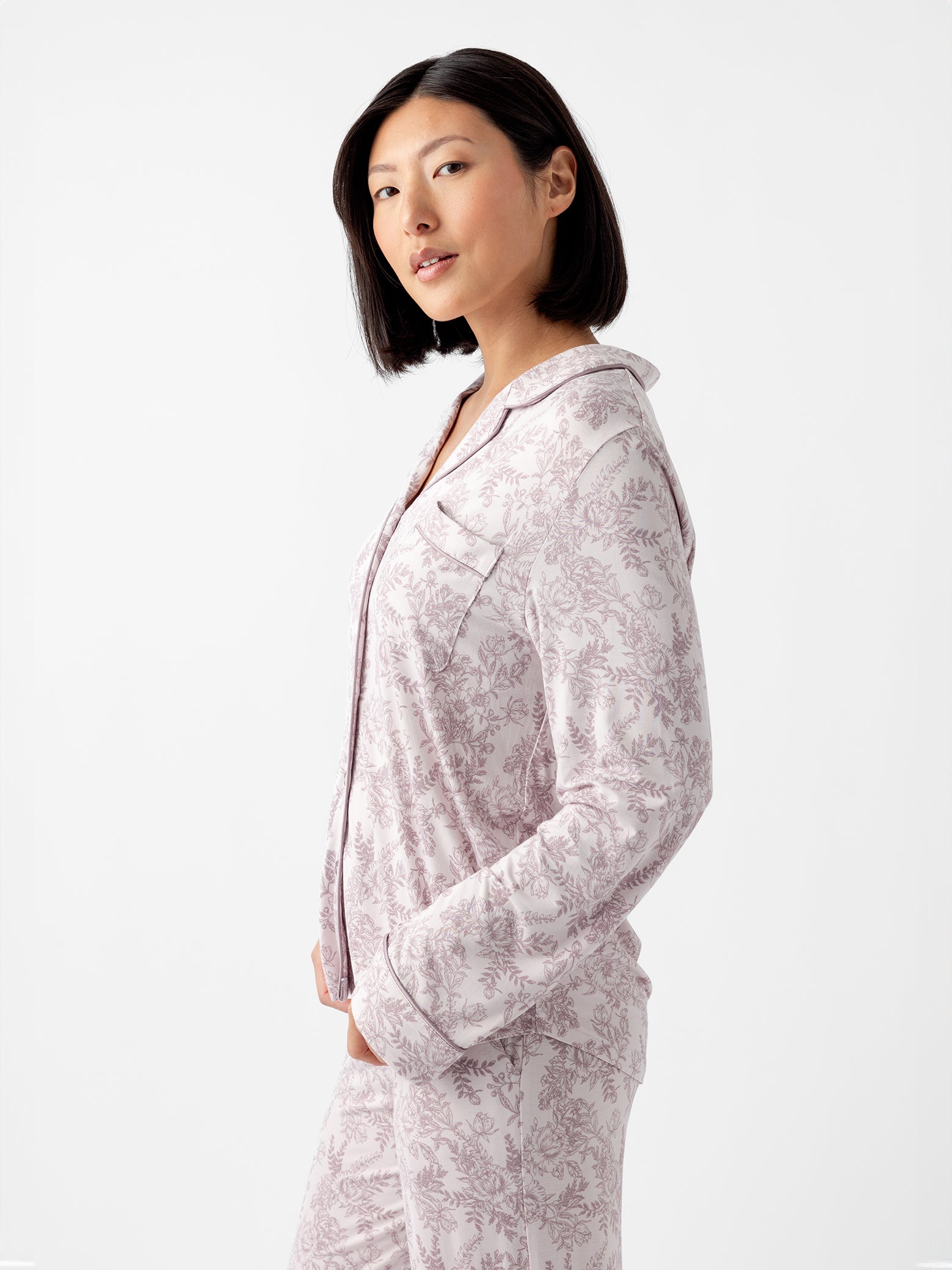 Side view of woman wearing lilac toile pajama shirt 