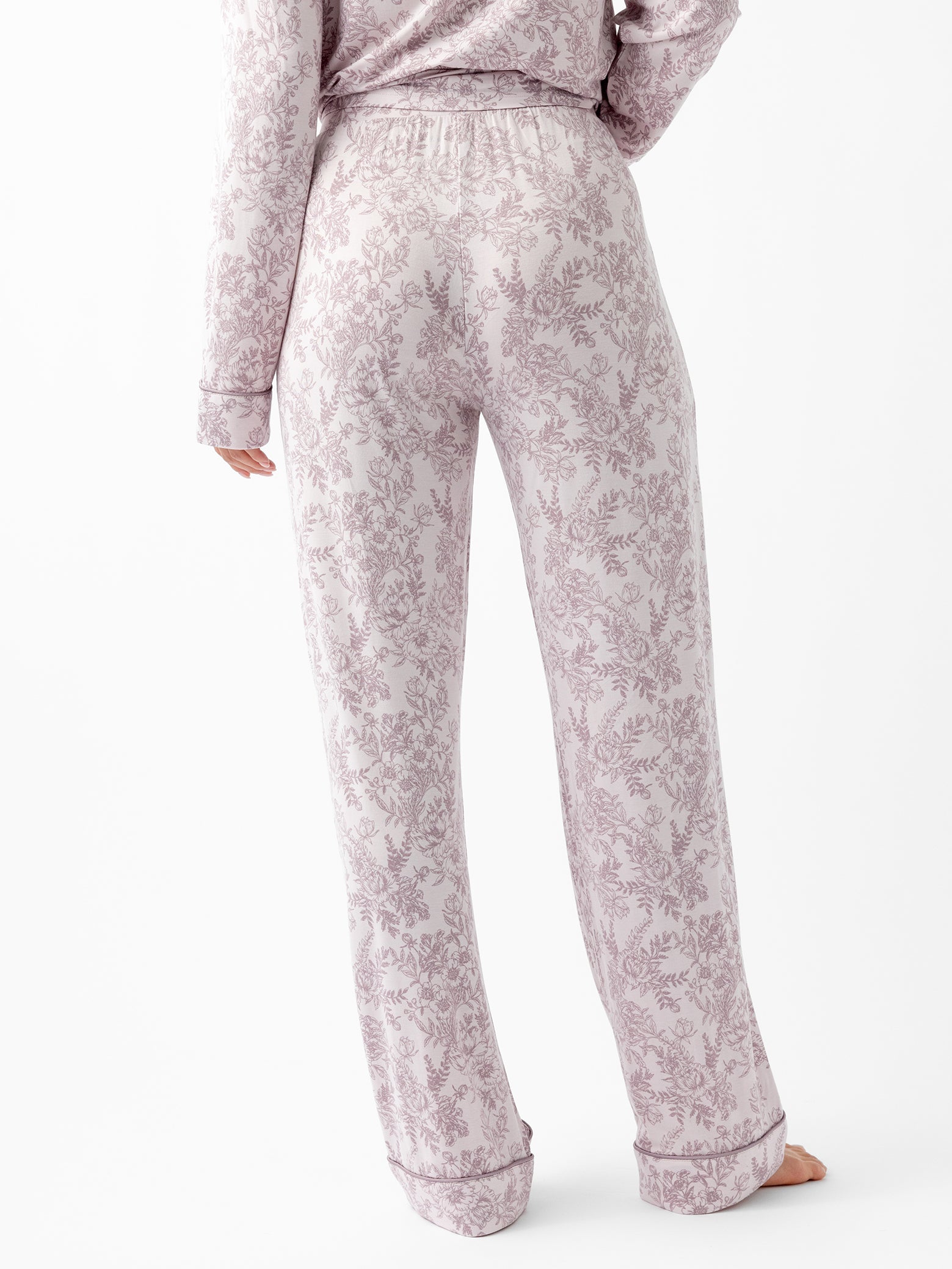 Back of woman in lilac toile pajama pants 