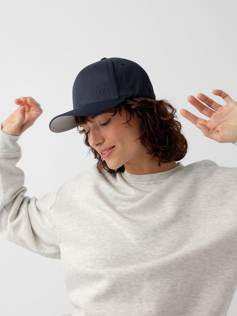 Side view of woman wearing navy urban classic hat