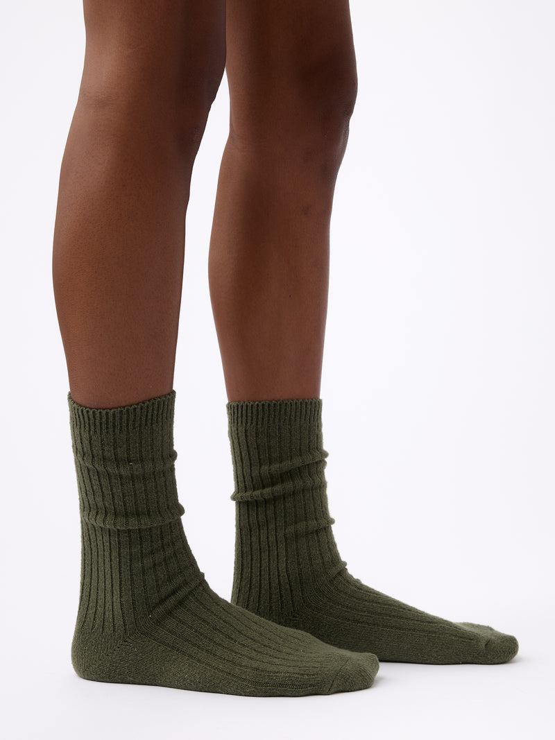 Person wearing Cozy Earth Plush Lounge Calf Sock 1-Pack in Olive