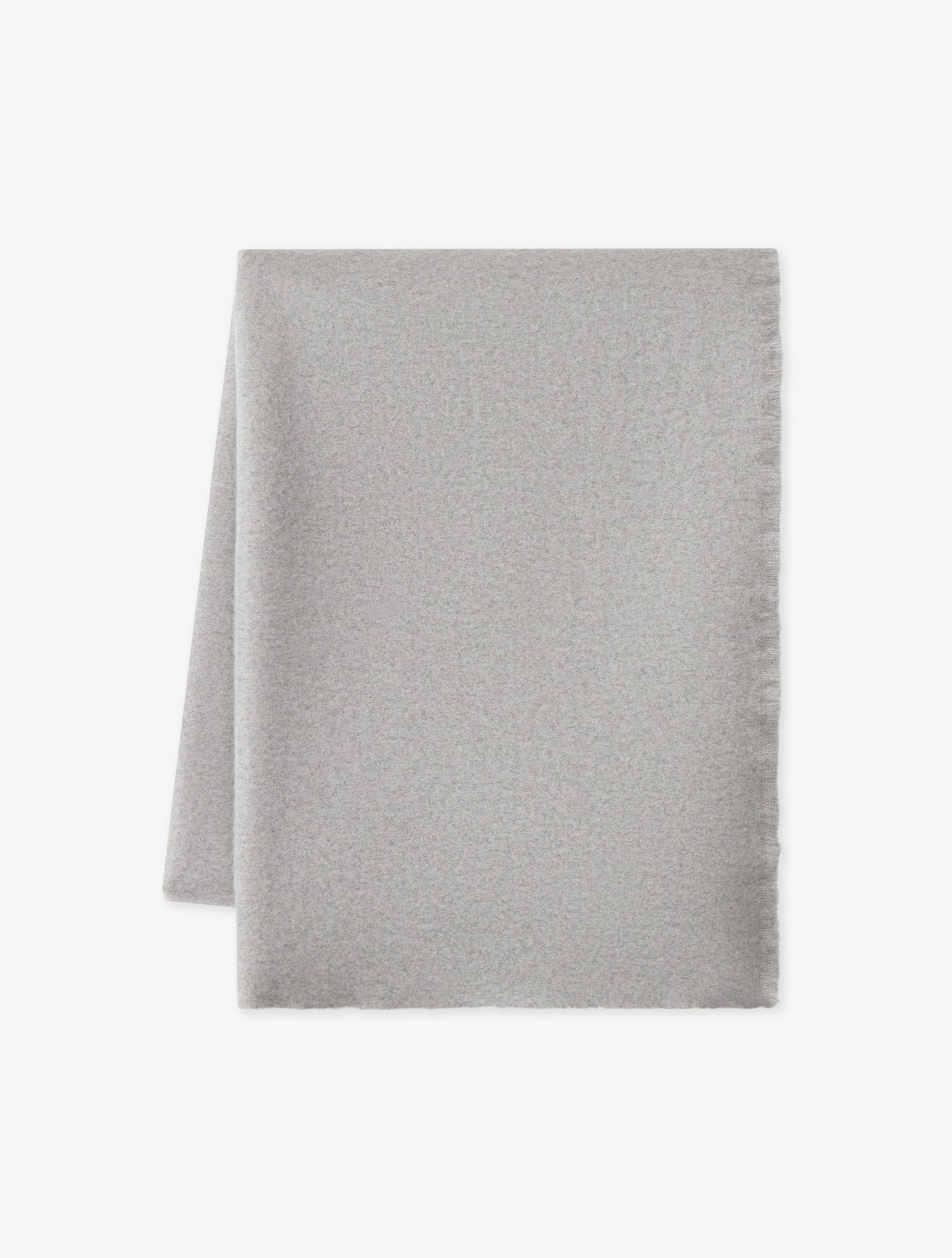 The Cashmere Fringe Blanket by Cozy Earth, shown in light gray and rectangular shape, is displayed flat on a white background with one corner folded over.|Color:Pebble