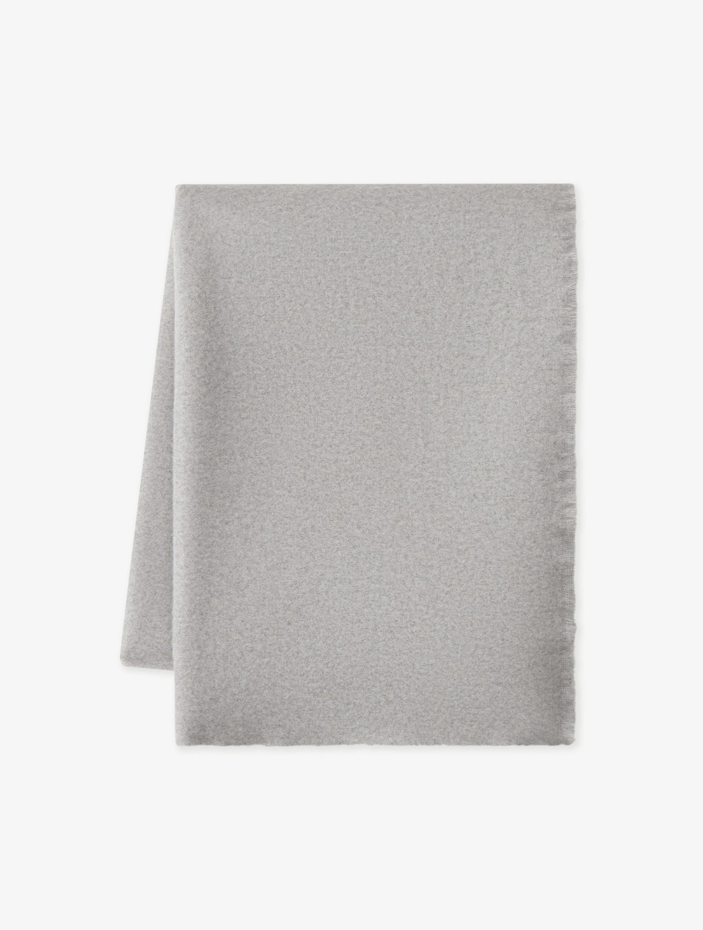 The Cashmere Fringe Blanket by Cozy Earth, shown in light gray and rectangular shape, is displayed flat on a white background with one corner folded over.|Color:Pebble