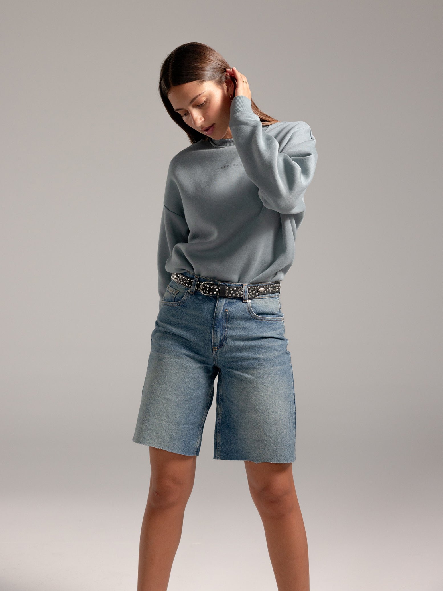 Woman wearing Smokey Blue CityScape Crewneck with grey background 