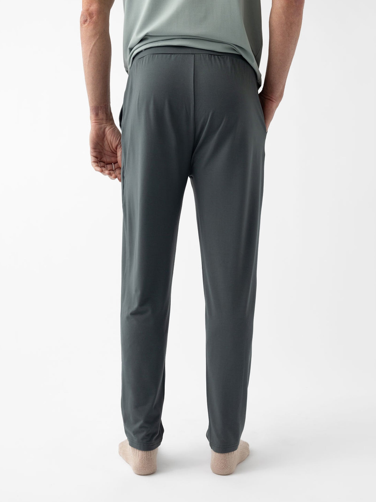 Back of man wearing storm pajama pants with white background 