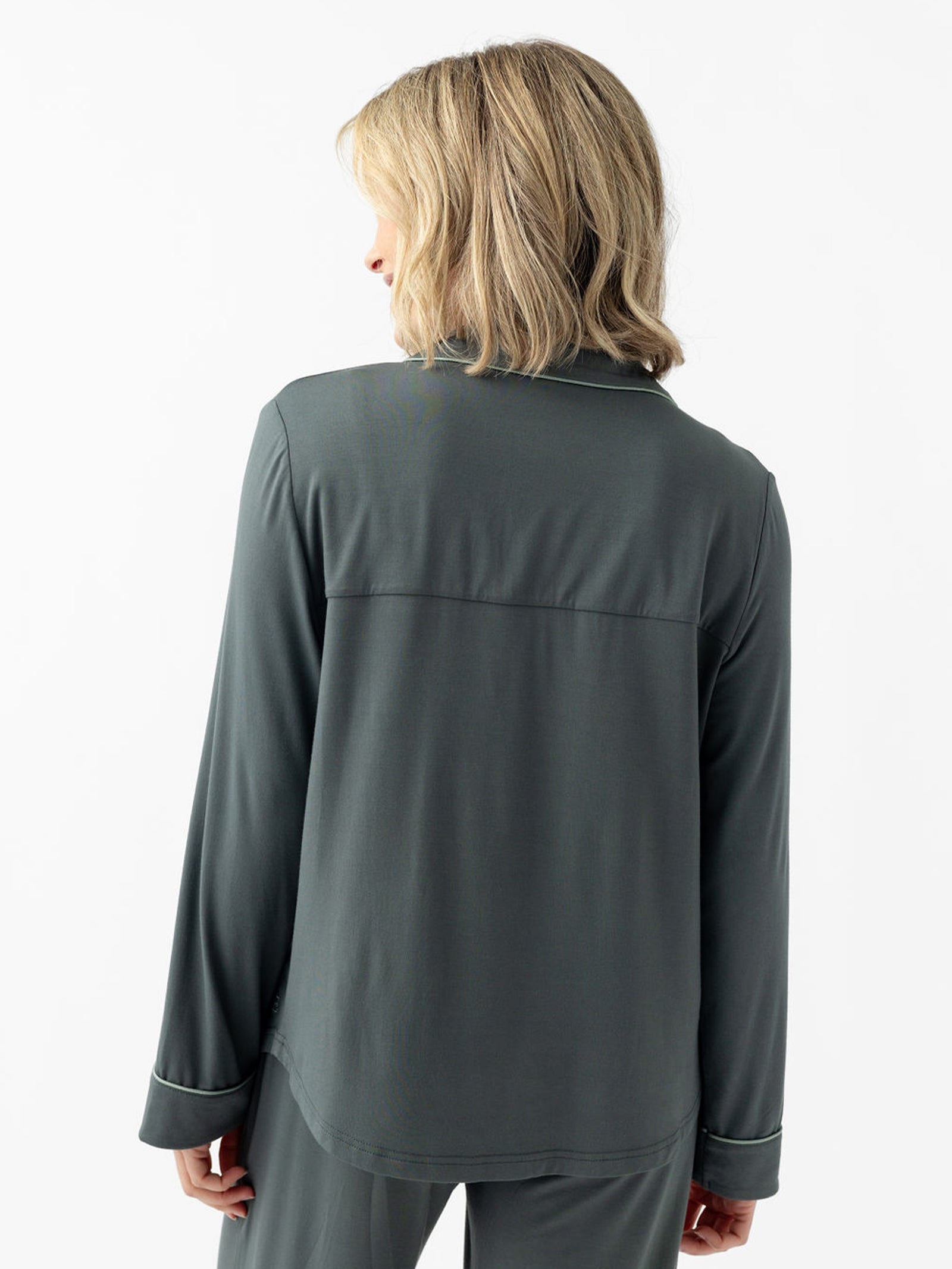 Back of woman wearing storm pajamas with white background 