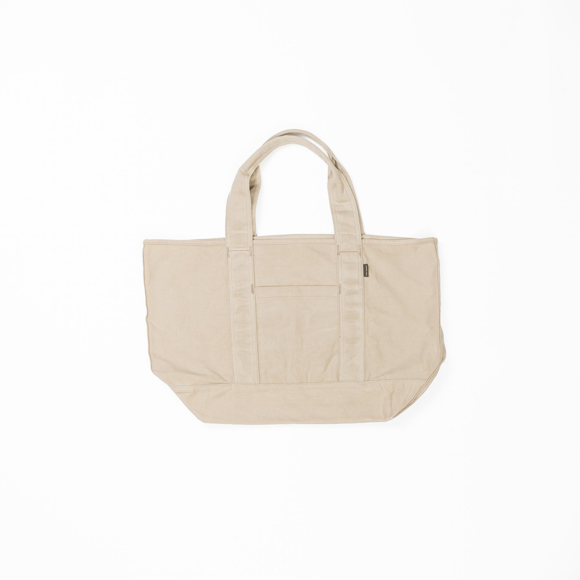 A large, beige Waxed Canvas Tote by Cozy Earth is displayed against a white background. The tote bag has two sturdy handles and features an outer pocket on the front. 