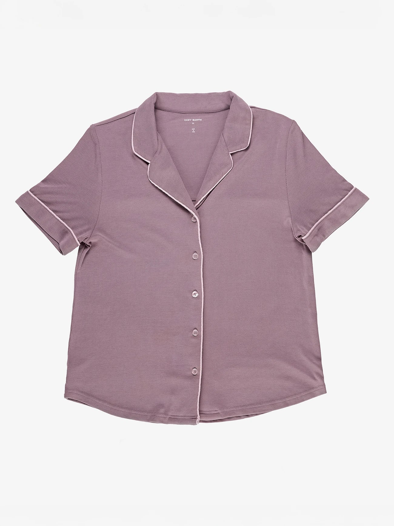 A short-sleeved purple button-up shirt with white piping on the collar and cuffs, from the Women's Rib-Knit Classic Short Sleeve Pajama Set by Cozy Earth, laid flat on a white background. 