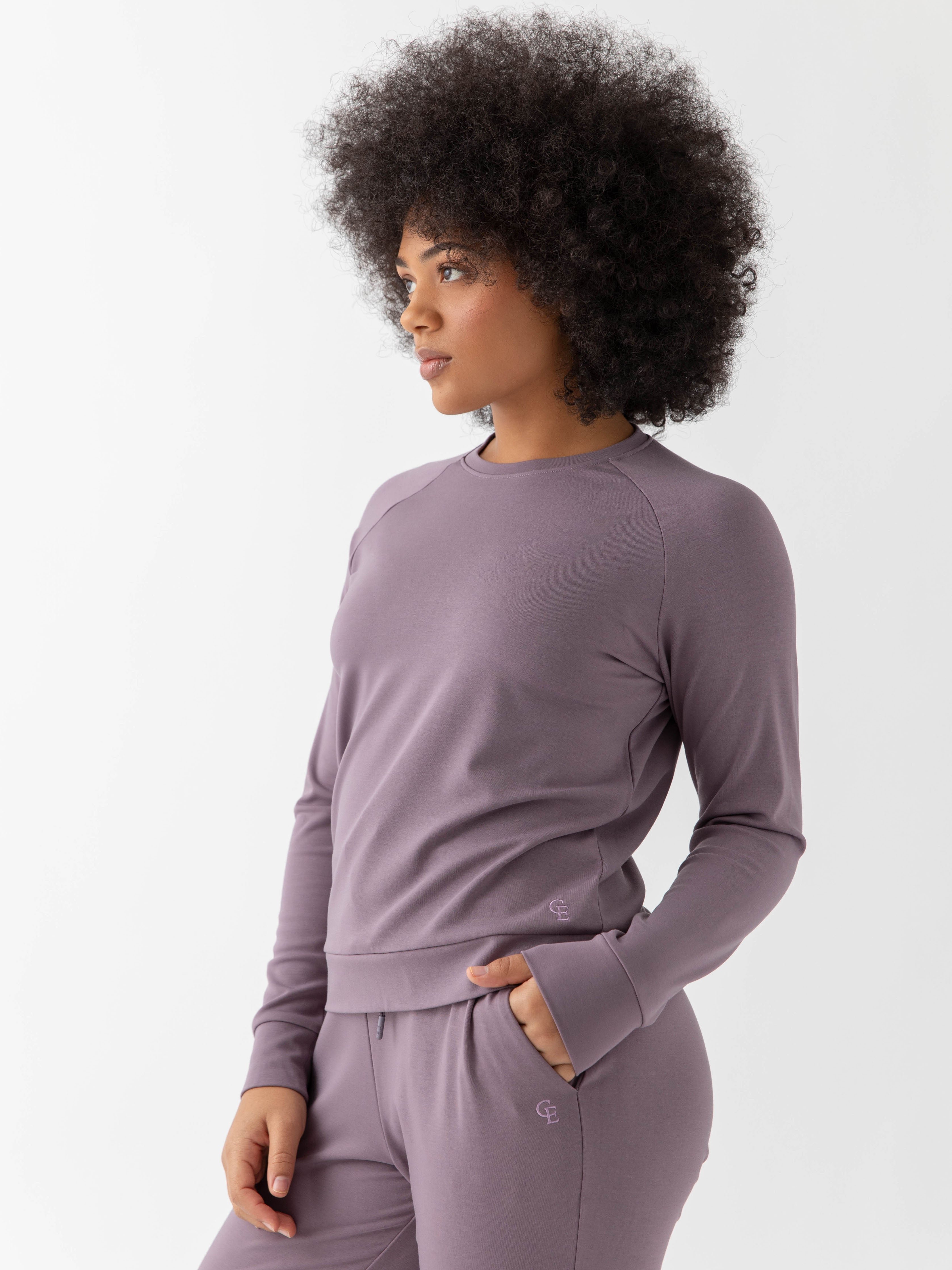 Twilight Bamboo Jogger Set modeled by a woman. The photo was taken in a high contrast setting, showing off the colors and lines of the pajamas. 