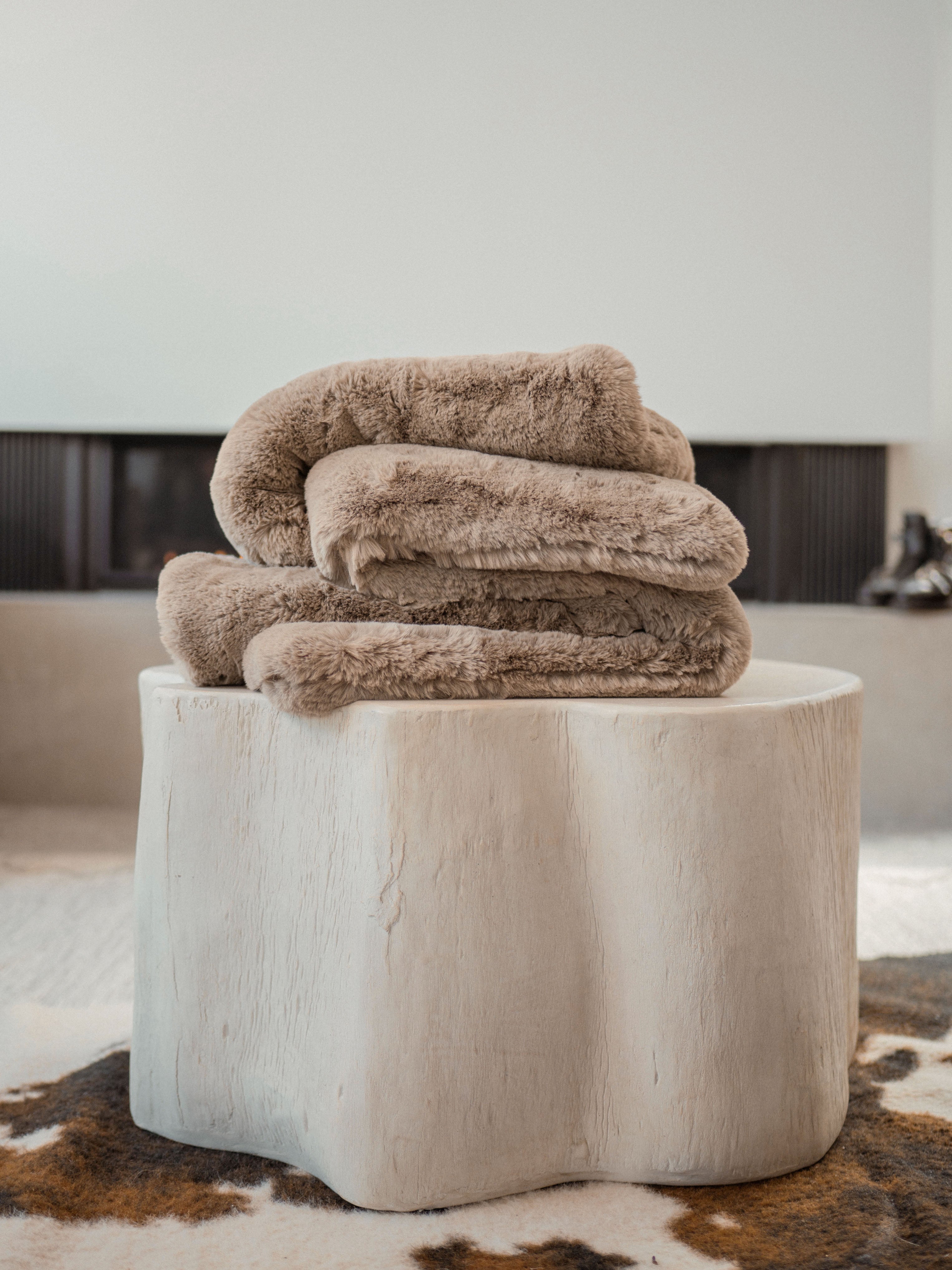 Walnut Oversized Throw Cuddle Blanket on a stool