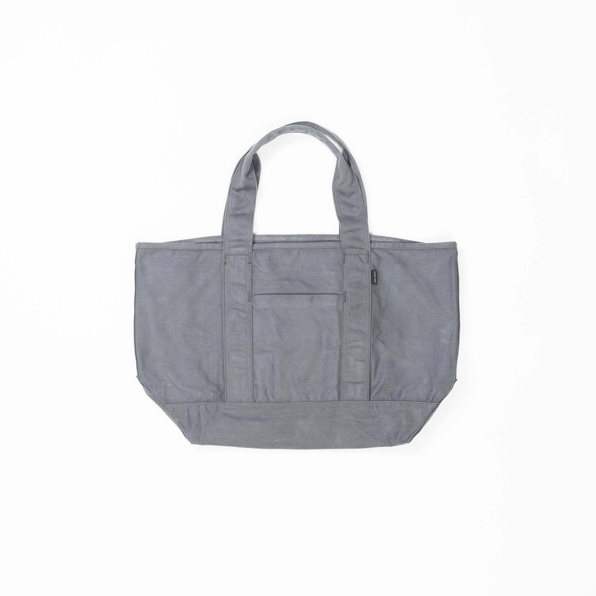 The Waxed Canvas Tote by Cozy Earth is a plain gray bag featuring double handles and a central exterior pocket. Crafted from durable fabric, it is displayed against a white background in the photograph. |Color:Washed Navy