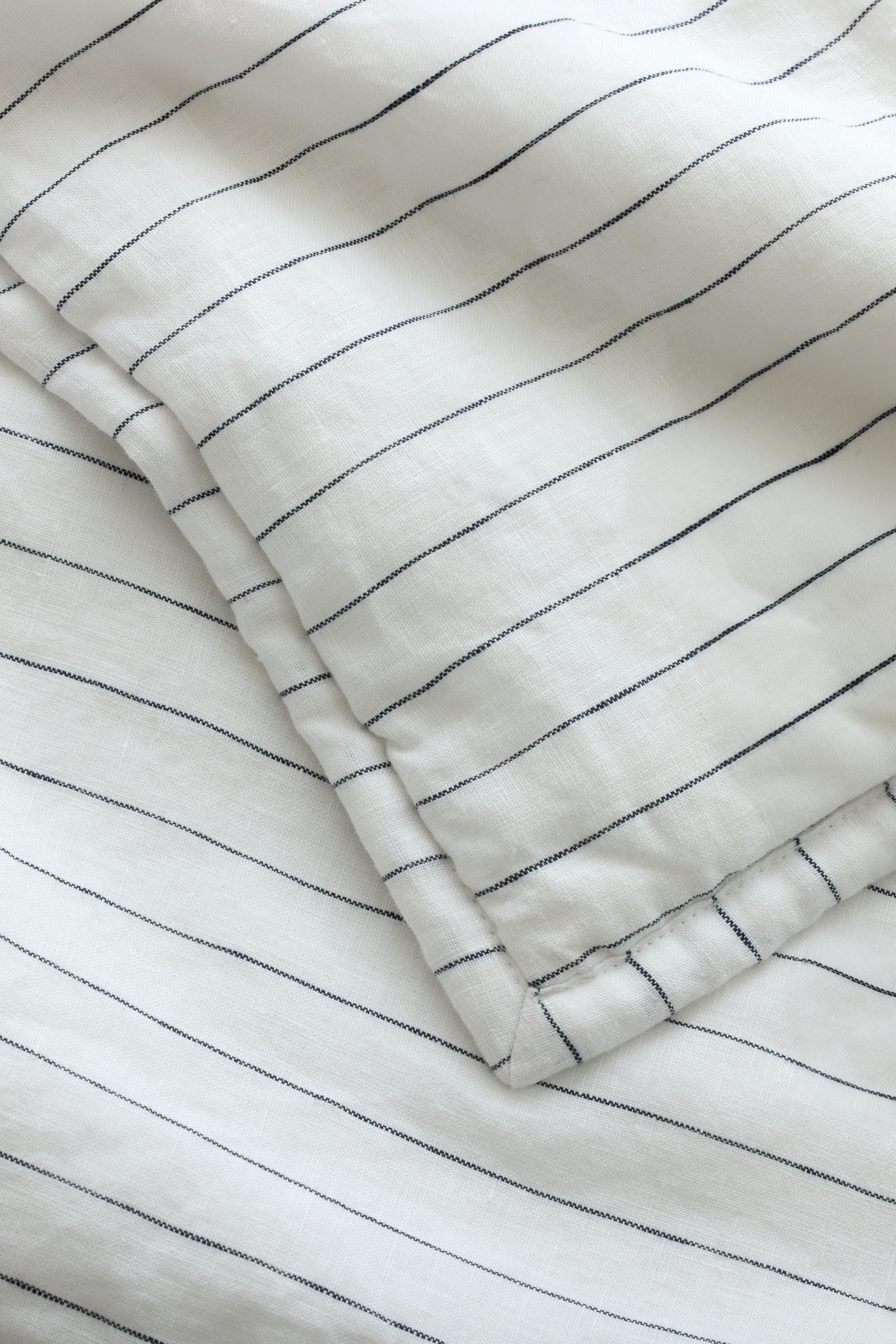 Close up of charcoal pencil stripe fabric 