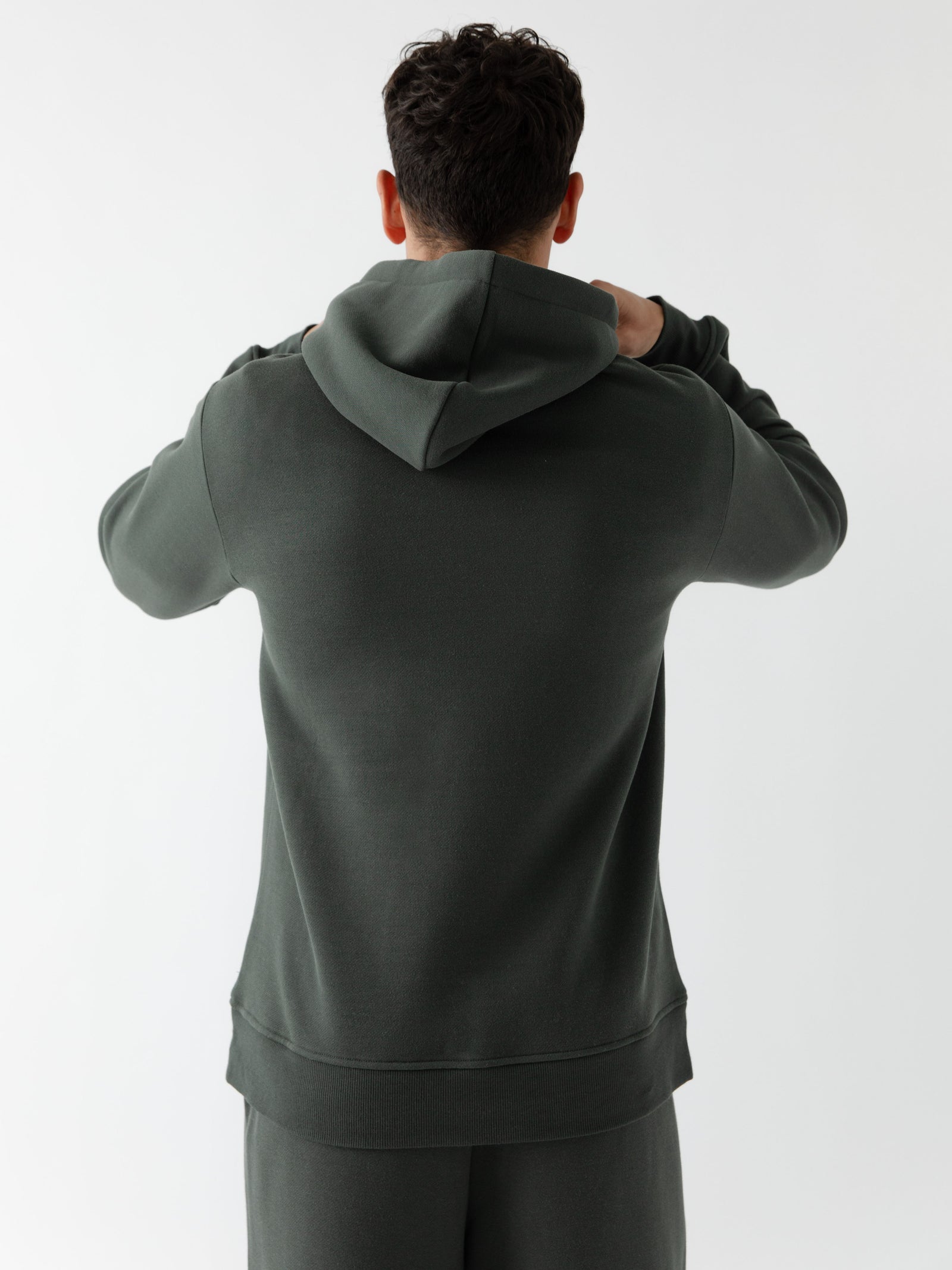 Back of man wearing storm cityscape hoodie with white background 