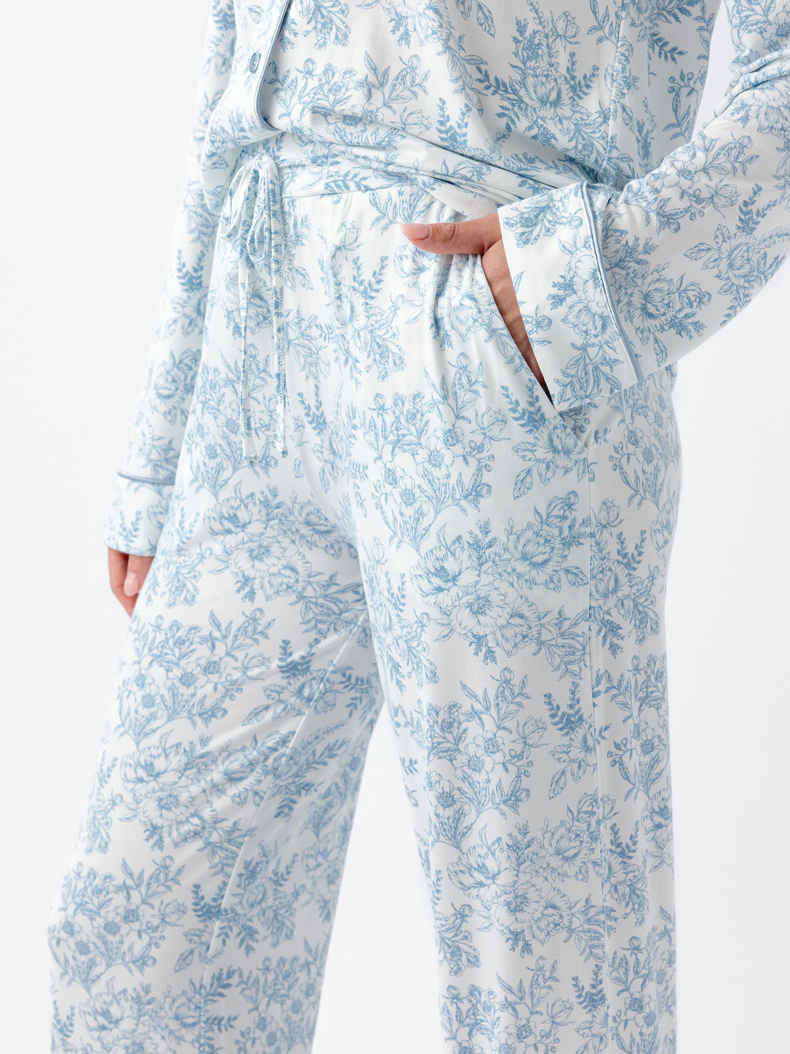 Close up of pocket and waist of blue toile pajama pants 