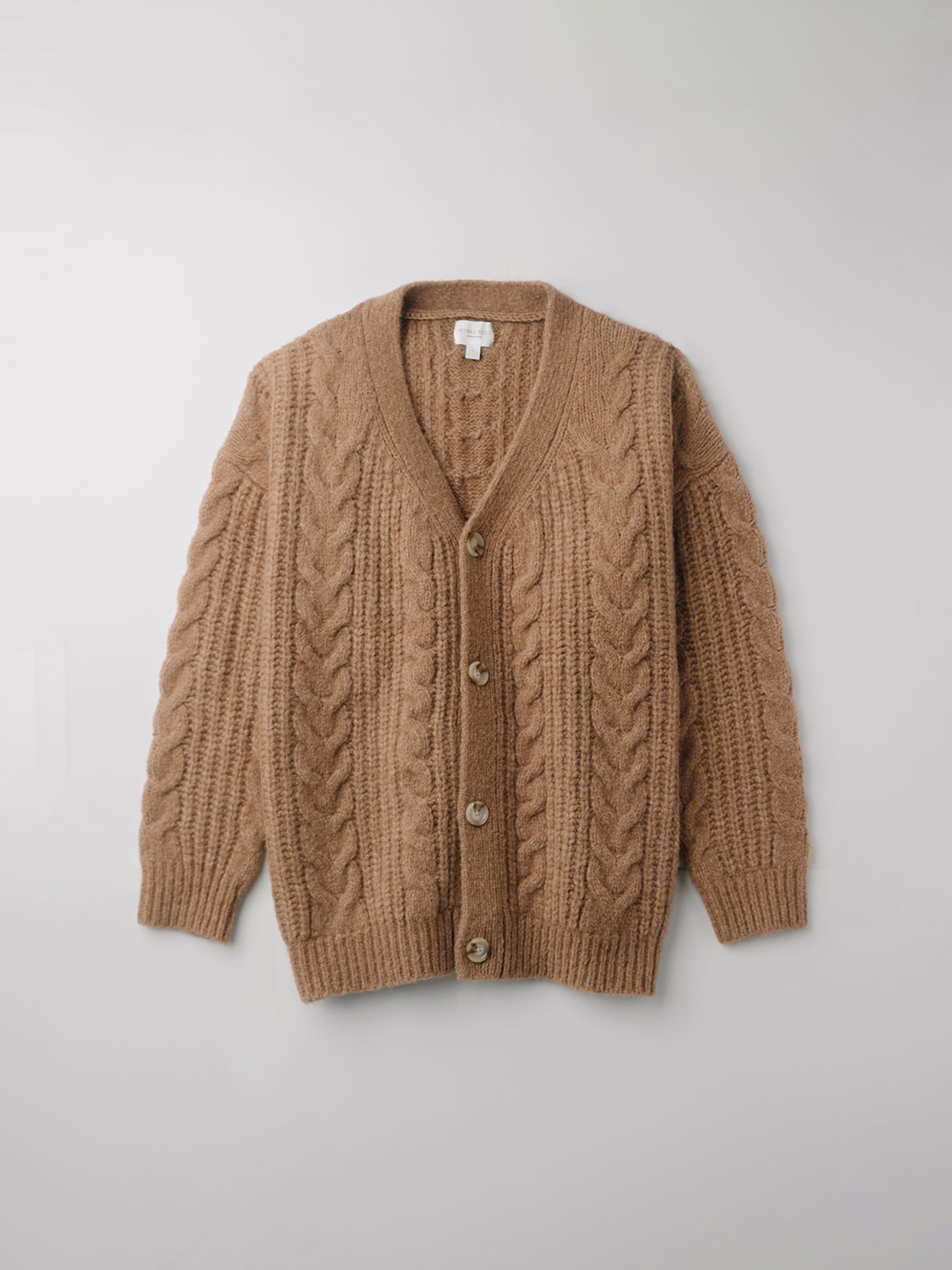 Flay lay of camel cable knit cardigan with white background 