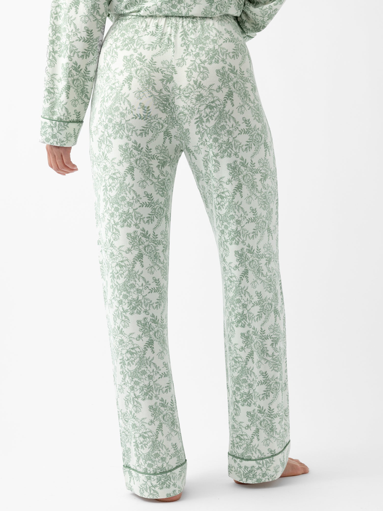 Back of woman in celadon toile pajama pants 
