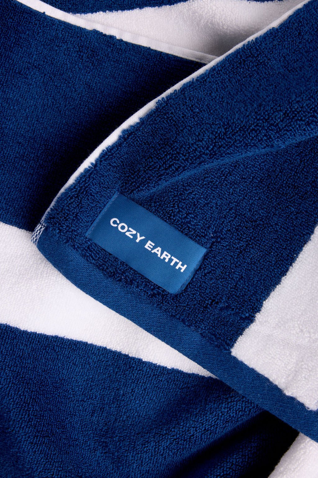 Close-up of a Cozy Earth "Classic Stripe Resort Towel" in Pacific, highlighting its soft texture and vibrant colors. 
