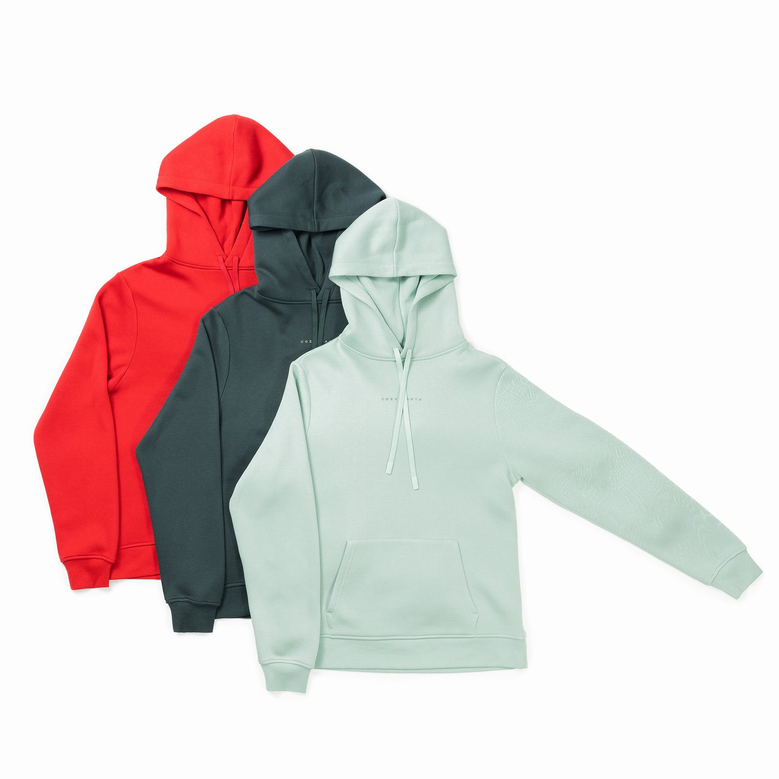 Three Men's CityScape Hoodies from Cozy Earth, available in red, dark green, and light green. Each features a front pocket and drawstrings on the hood. They are displayed side by side, presenting the front view. 