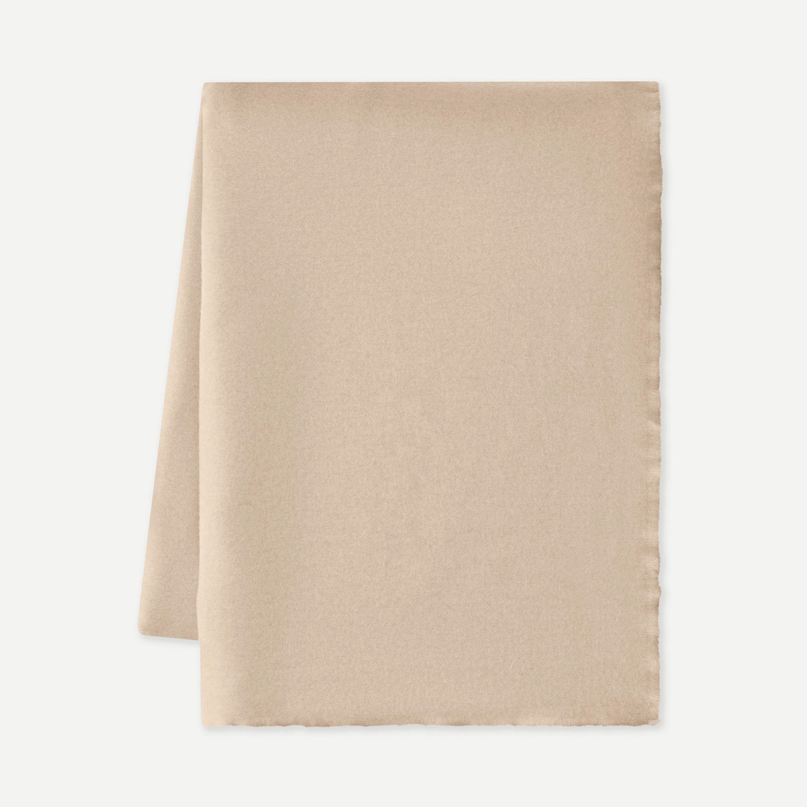 Flat lay of dune cashmere fringe blanket with white background 