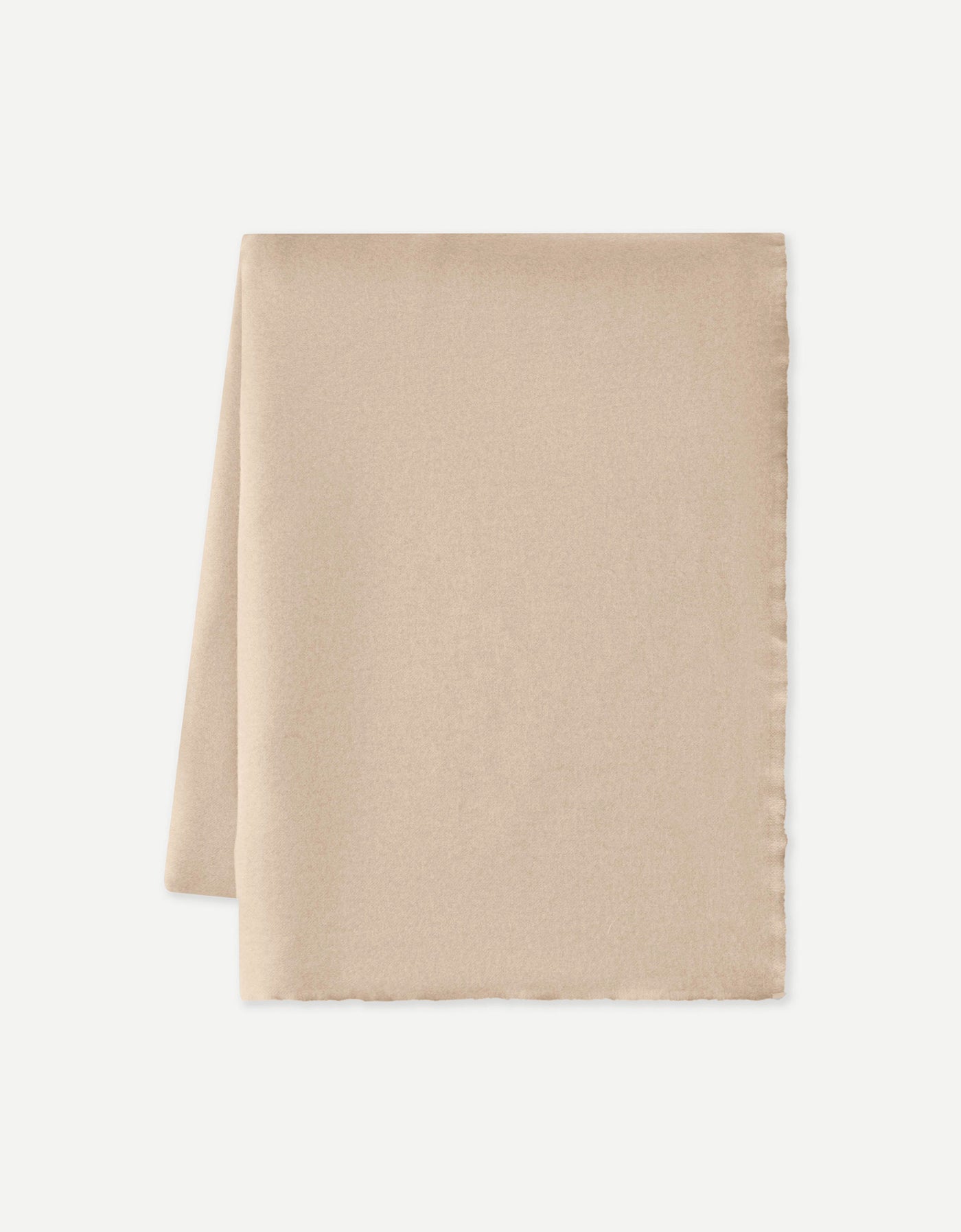 A neatly folded Cozy Earth Cashmere Fringe Blanket in beige, crafted from soft, lightweight cashmere, displayed against a plain white background.|Color:Dune