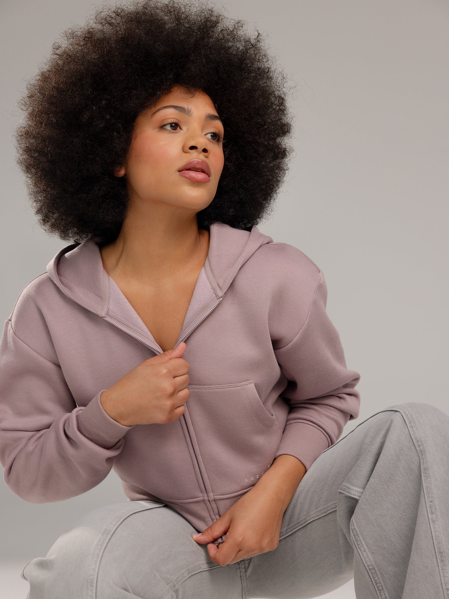 Woman wearing Dusty Orchid CityScape Cropped Full Zip with grey background 