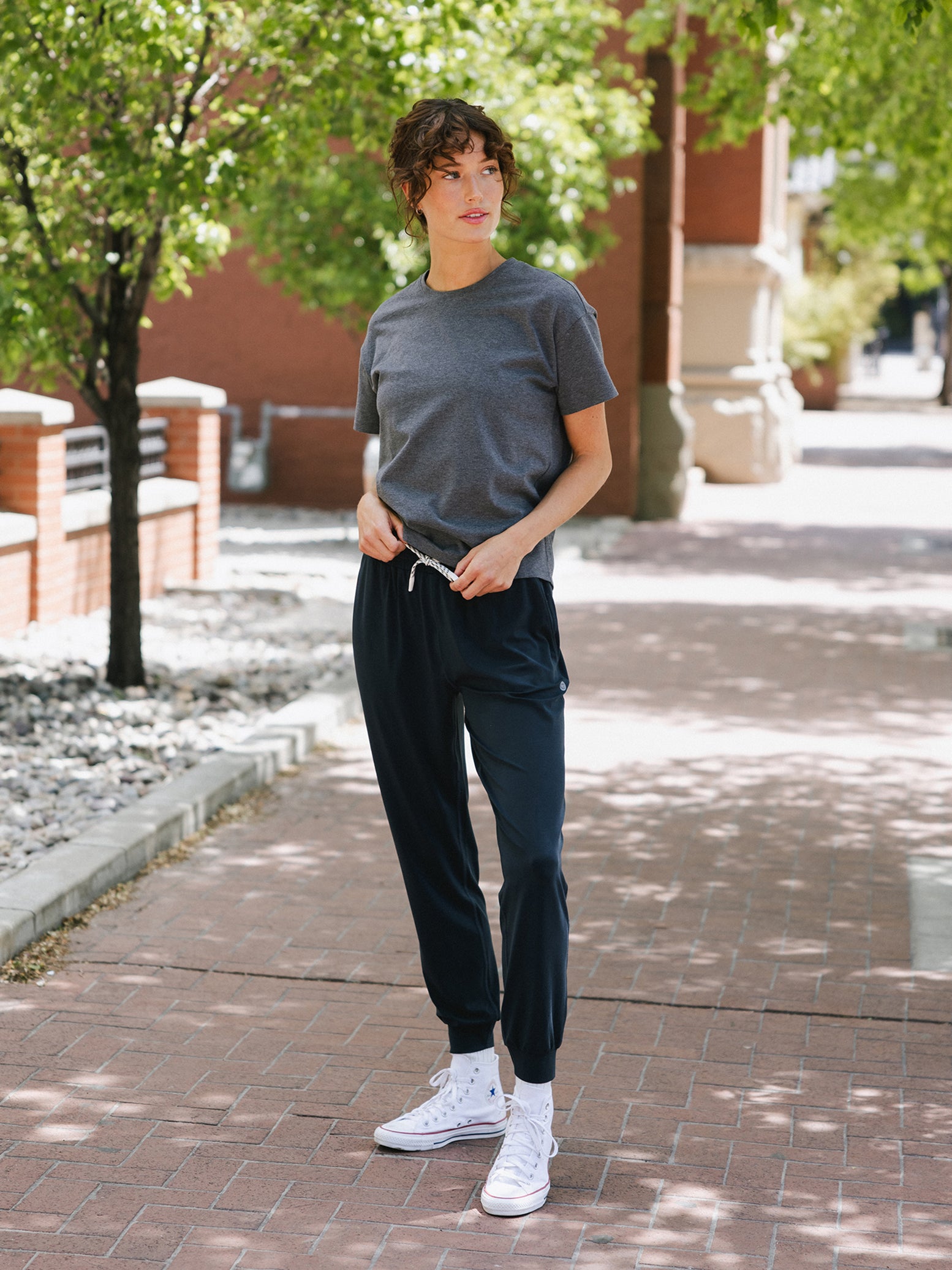 Eclipse Studio Jogger. The Studio Joggers are worn by a woman photographed with a city type background. 